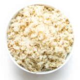a white bowl filled with cauliflower rice with a white background