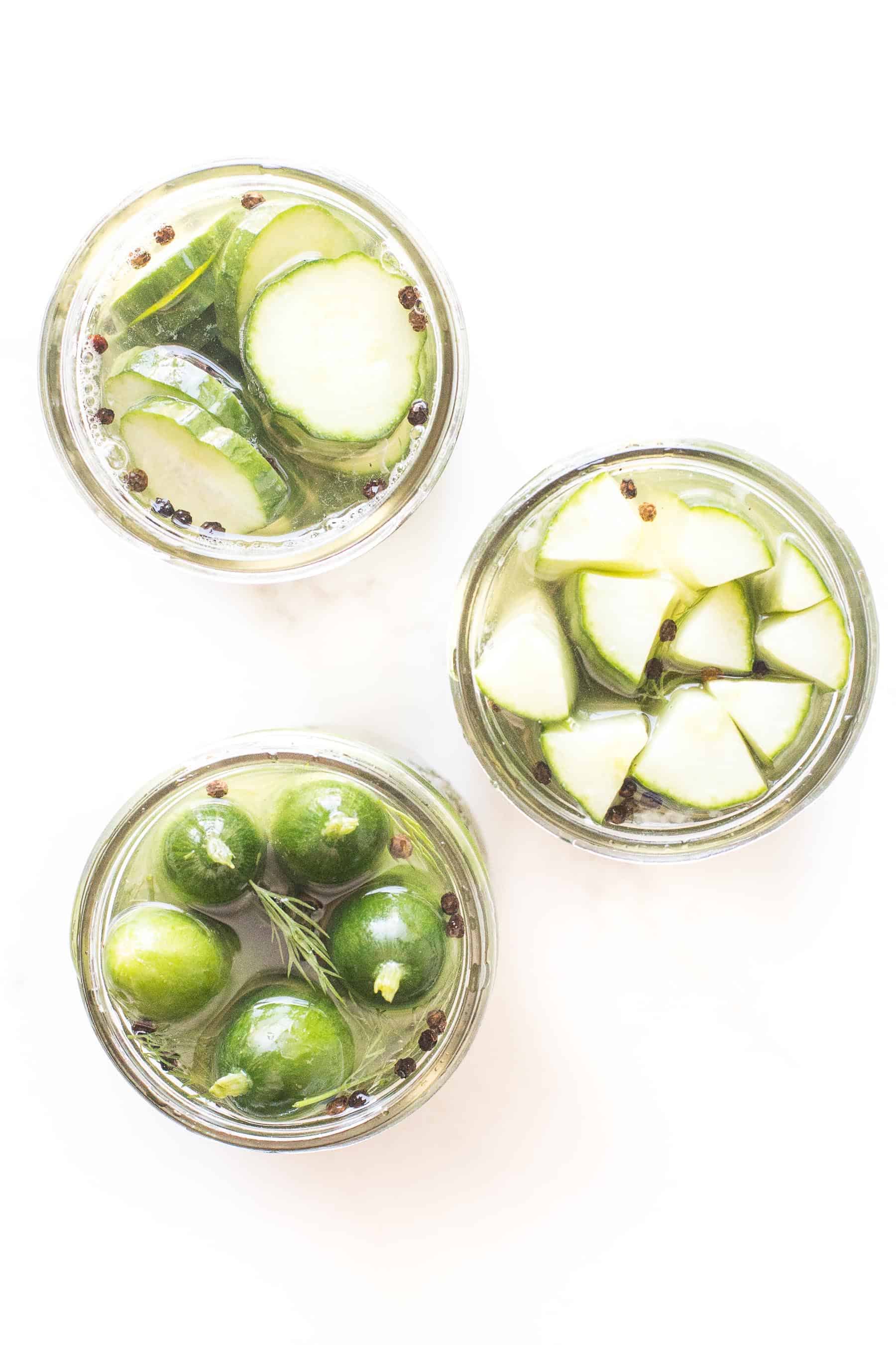 homemade pickles in mason jars on a white background