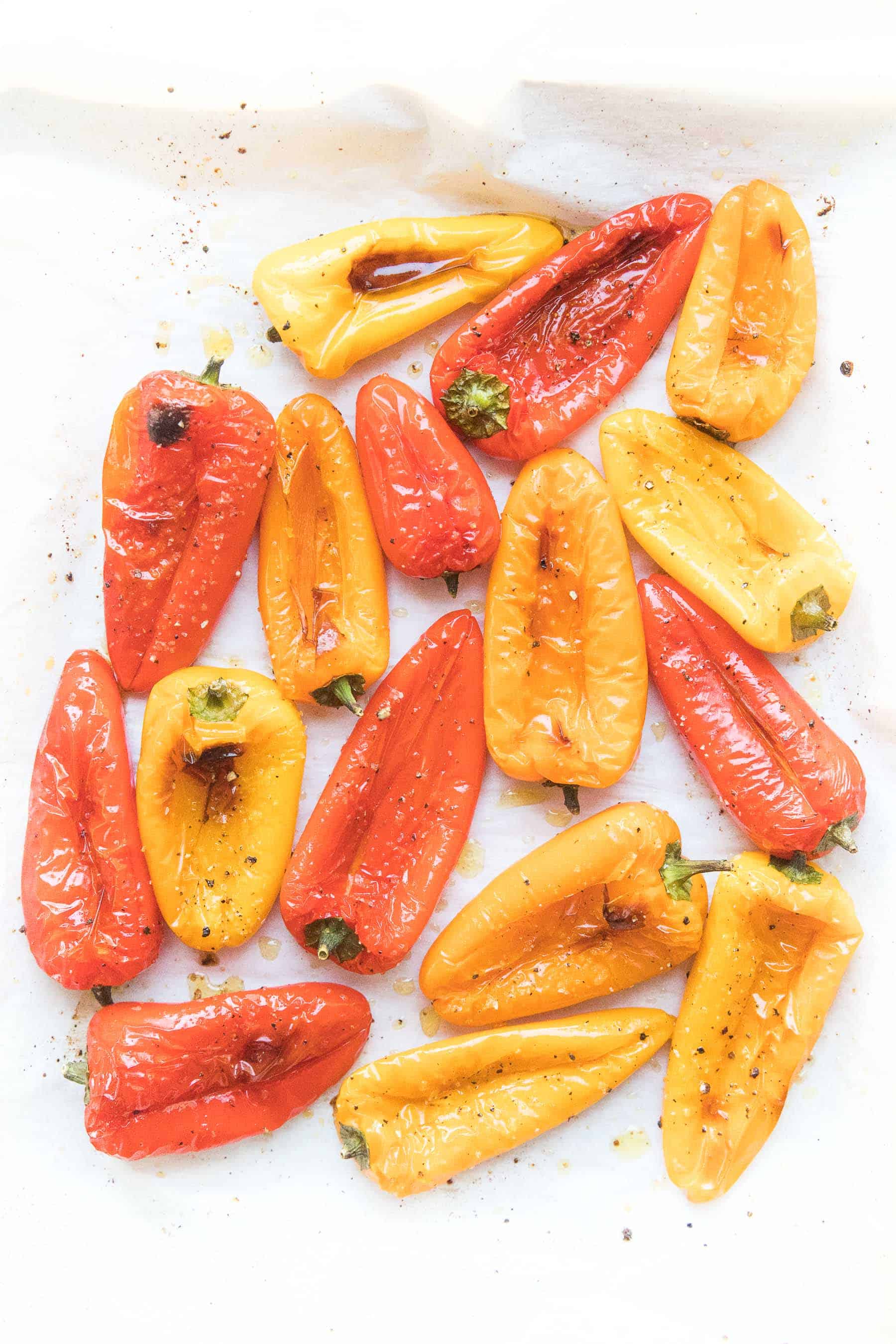 roasted mini bell peppers on parchment paper