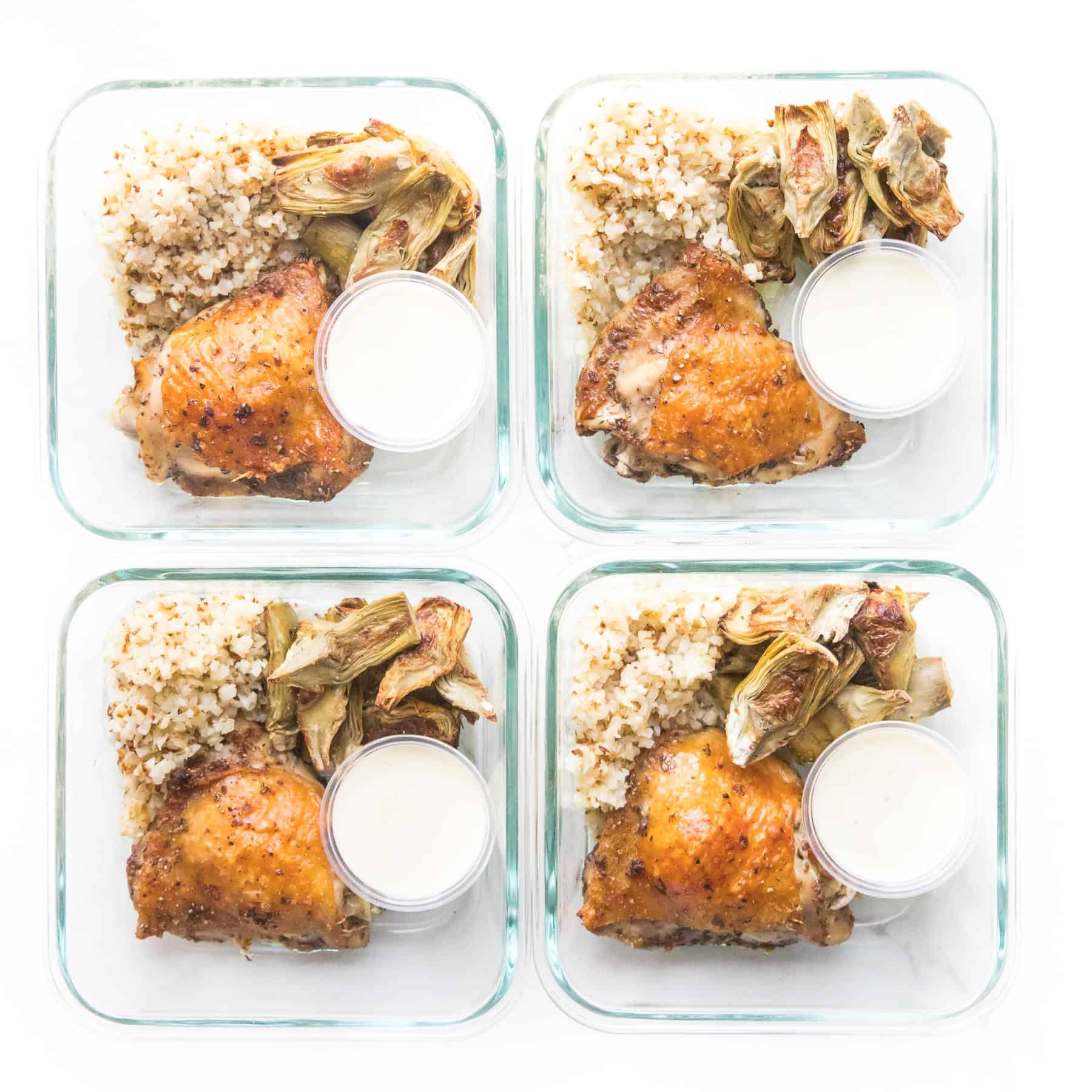chicken thigh, artichokes and cauliflower rice in a meal prep container