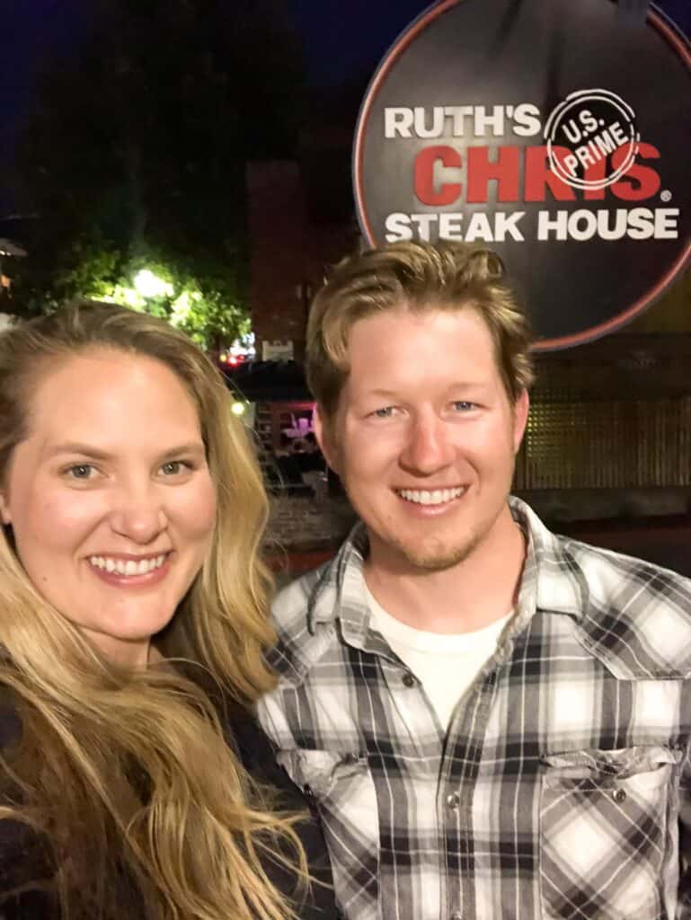 couple standing in front of ruth's chris steakhouse