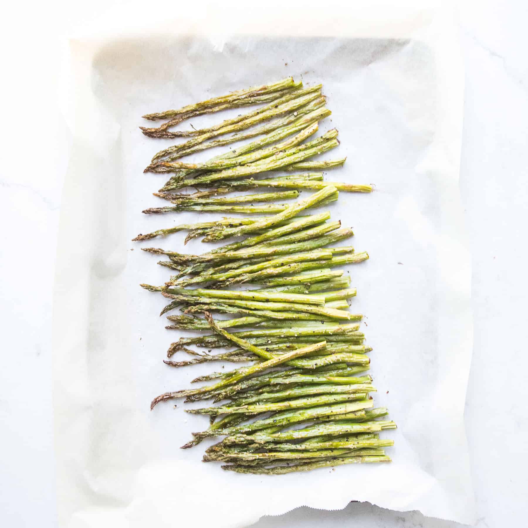 roasted asparagus on a rimmed baking sheet