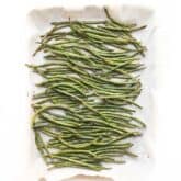 roasted green beans in a rimmed baking sheet