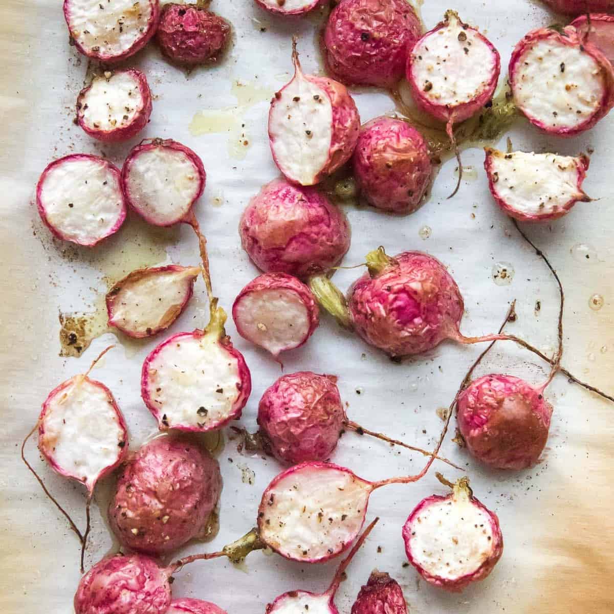 roasted radishes on a rimmed baking sheet