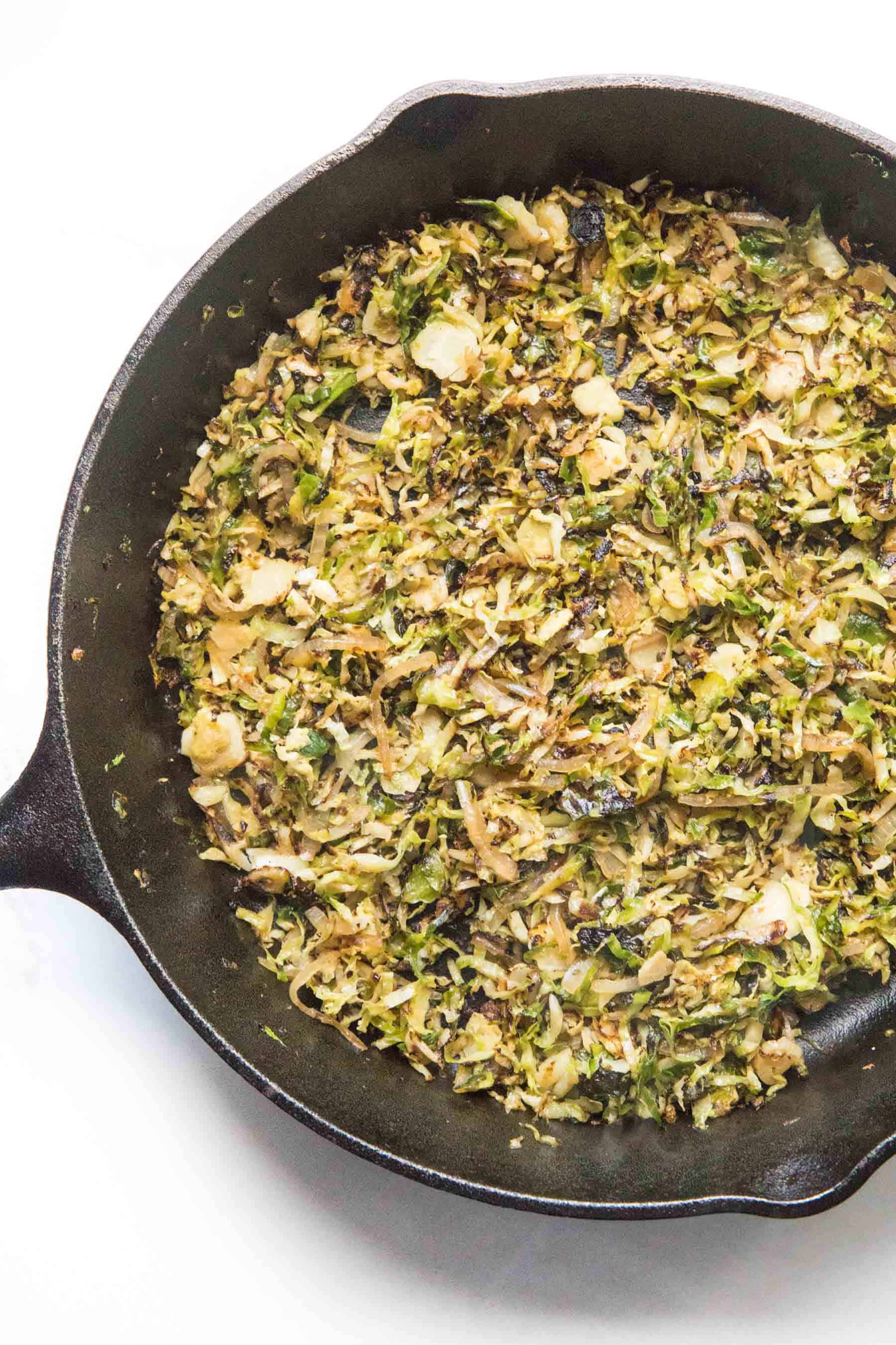 shaved brussels sprouts in a cast iron skillet
