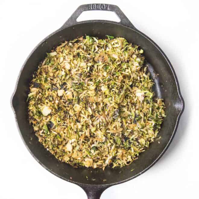 shaved brussels sprouts in a cast iron pan
