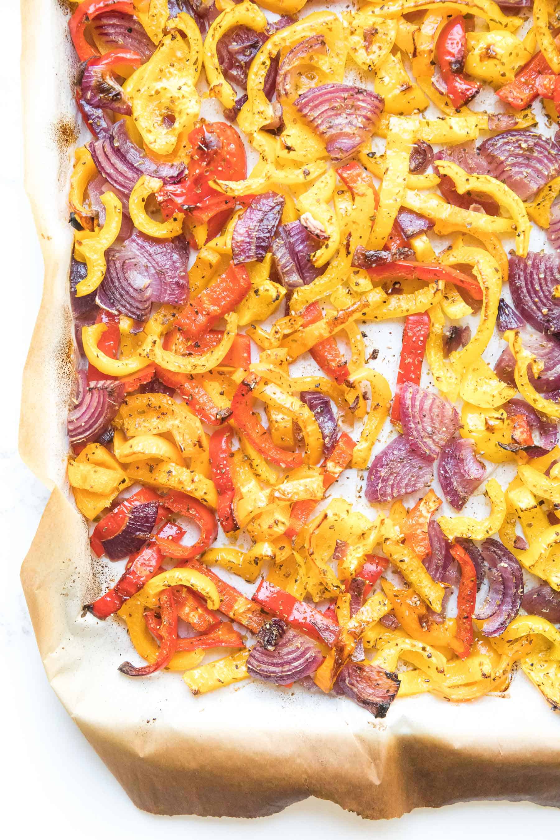 bell pepper and onion fajita veggies on a sheet pan