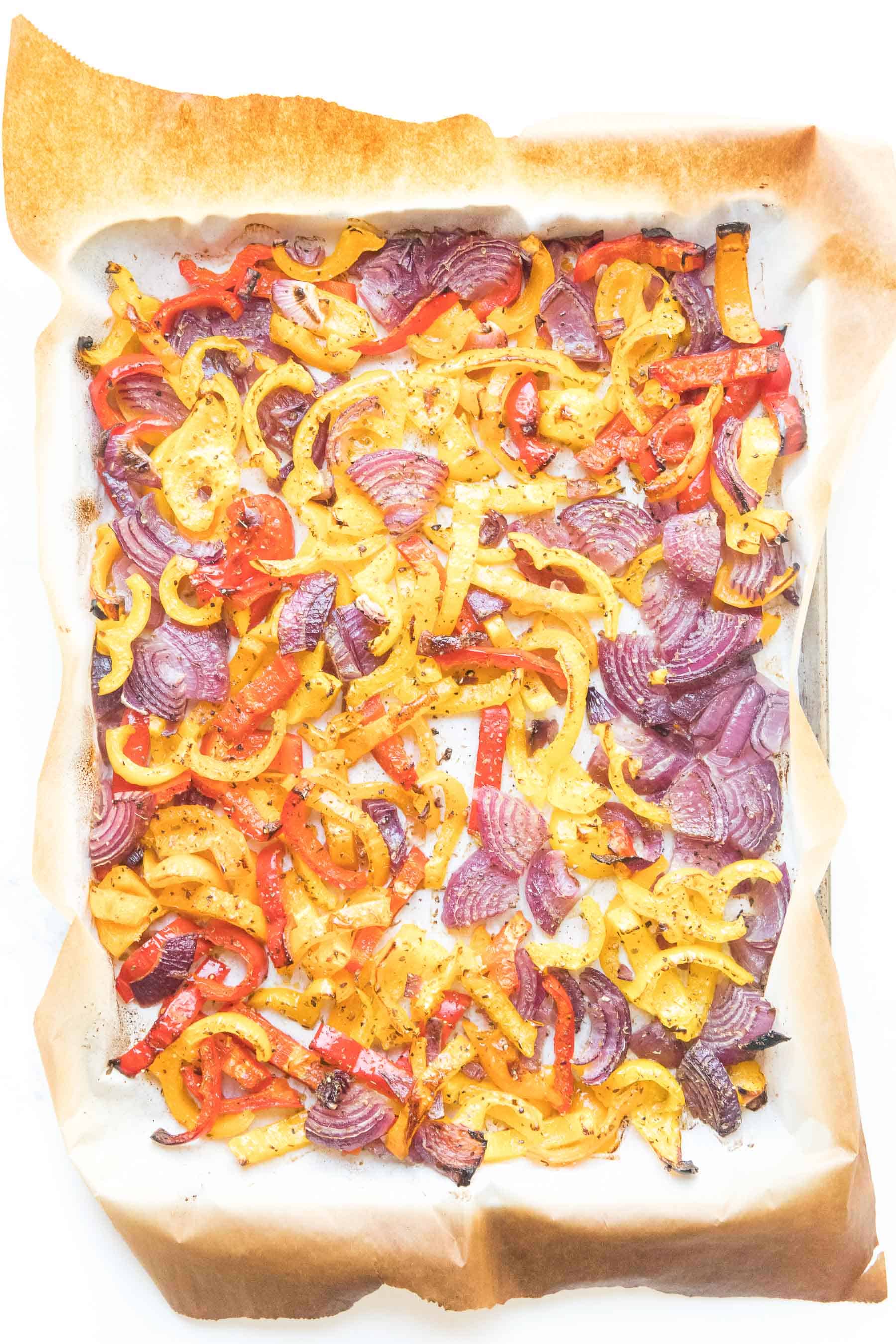 bell pepper and onion fajita veggies on a sheet pan