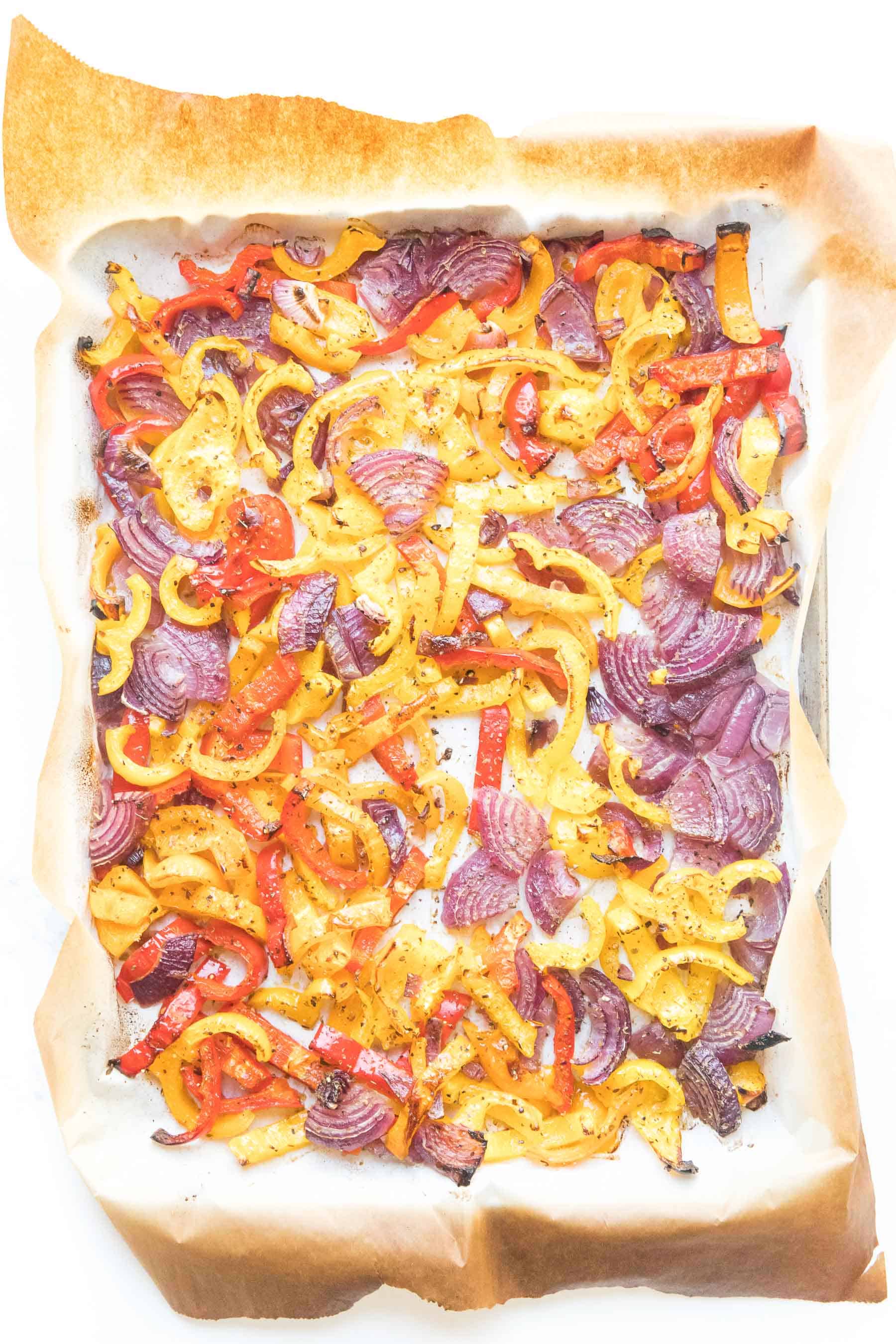 bell pepper and onion fajita veggies on a sheet pan