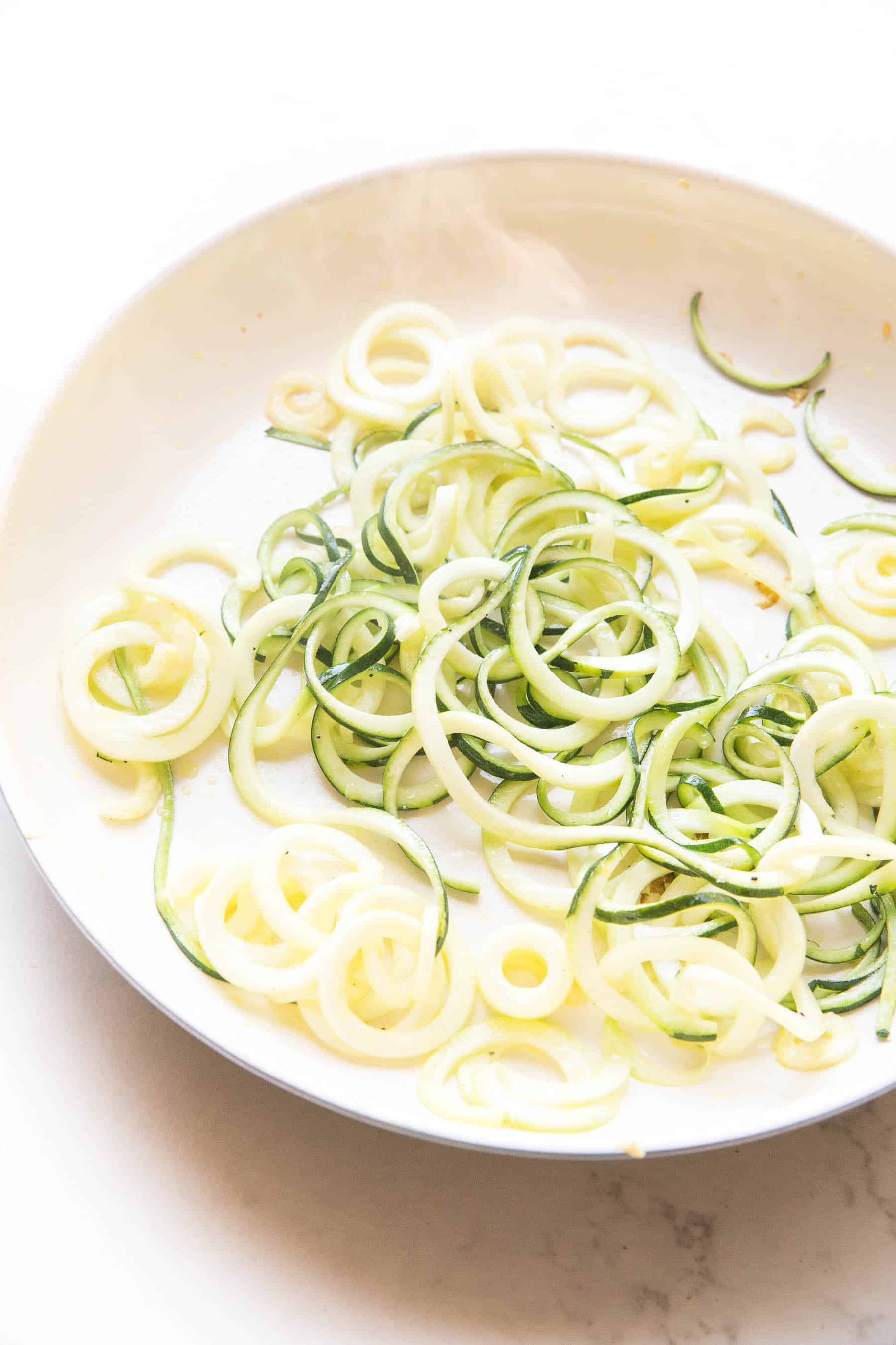 zucchini noodles in a white pan