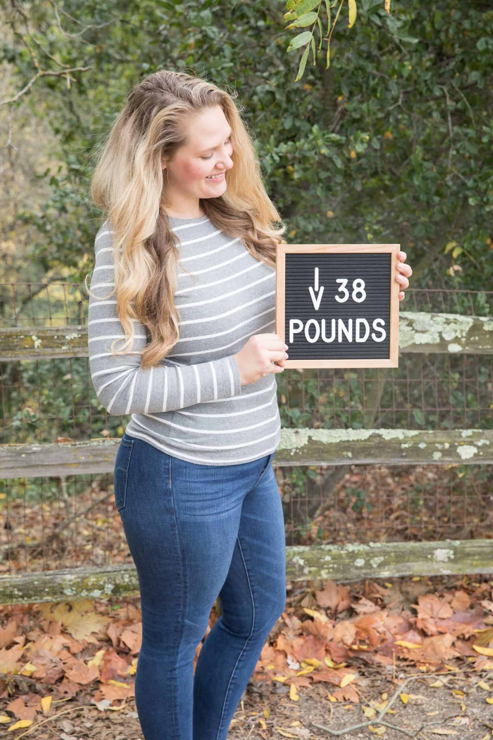 girl holding weight loss letterboard saying down 38 pounds