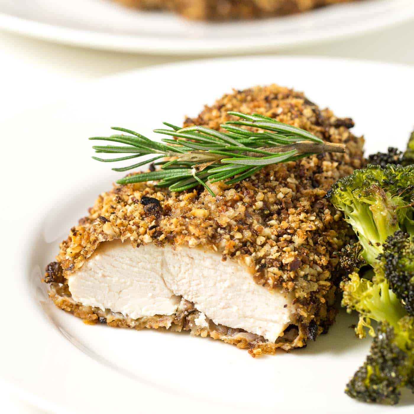 rosemary almond crusted chicken on a white plate