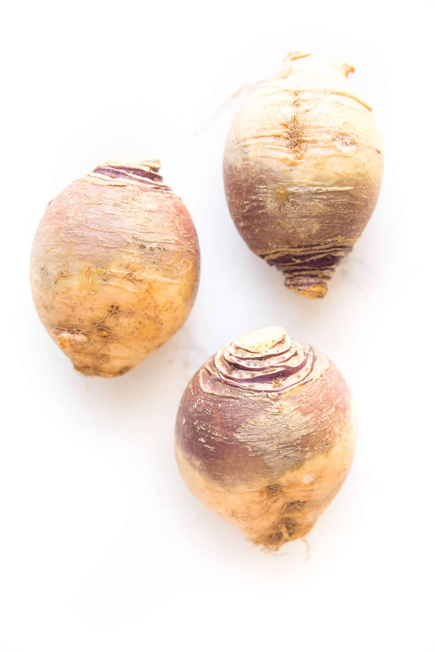 three rutabagas with a white background