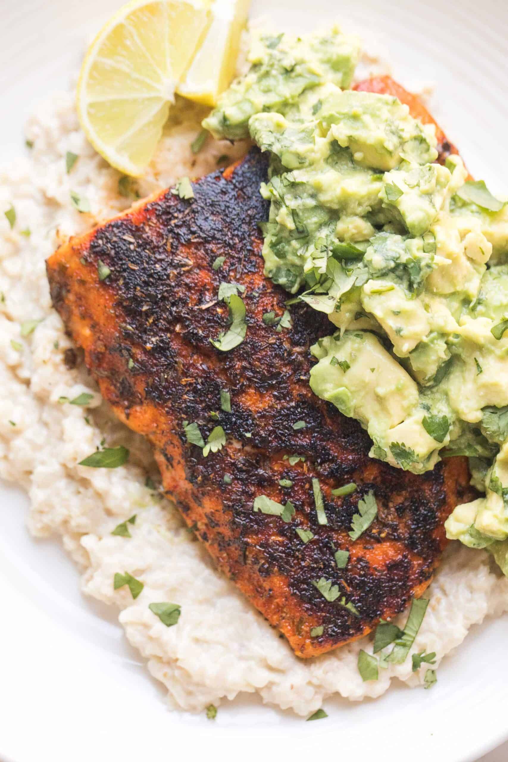 whole30 + keto blackened salmon over cauliflower risotto with chunky avocado topping