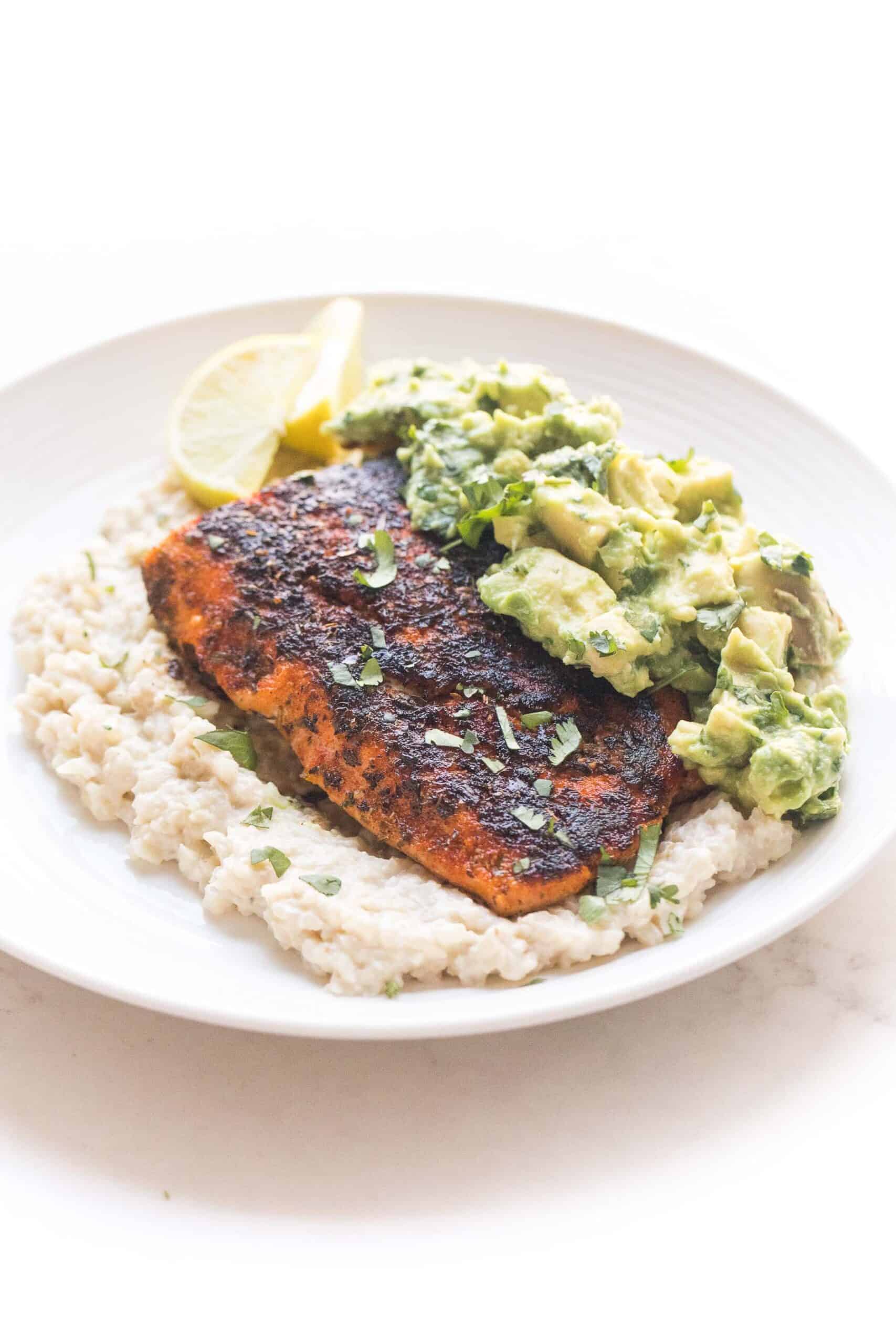 whole30 + keto blackened salmon over cauliflower risotto with chunky avocado topping