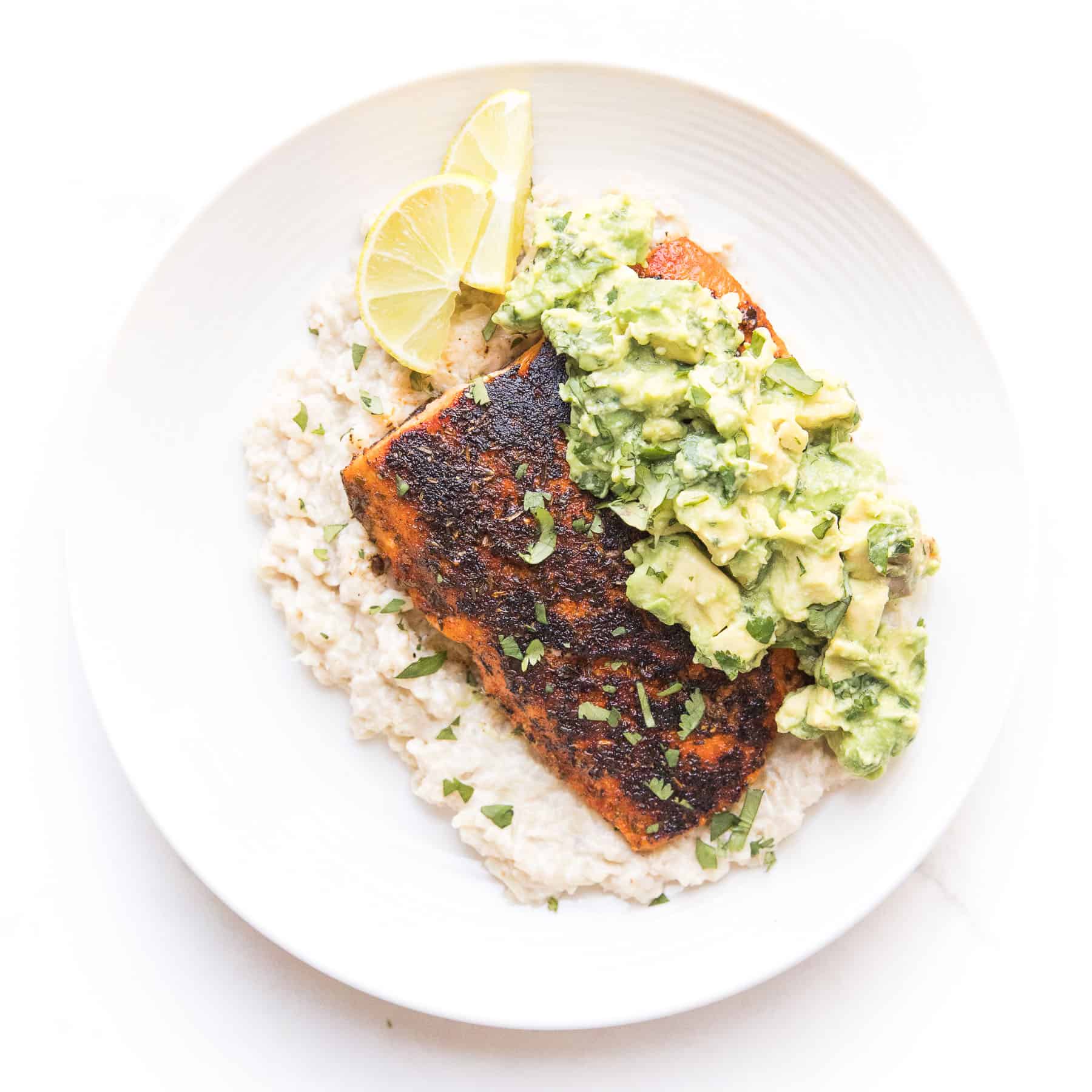 whole30 + keto blackened salmon over cauliflower risotto with chunky avocado topping