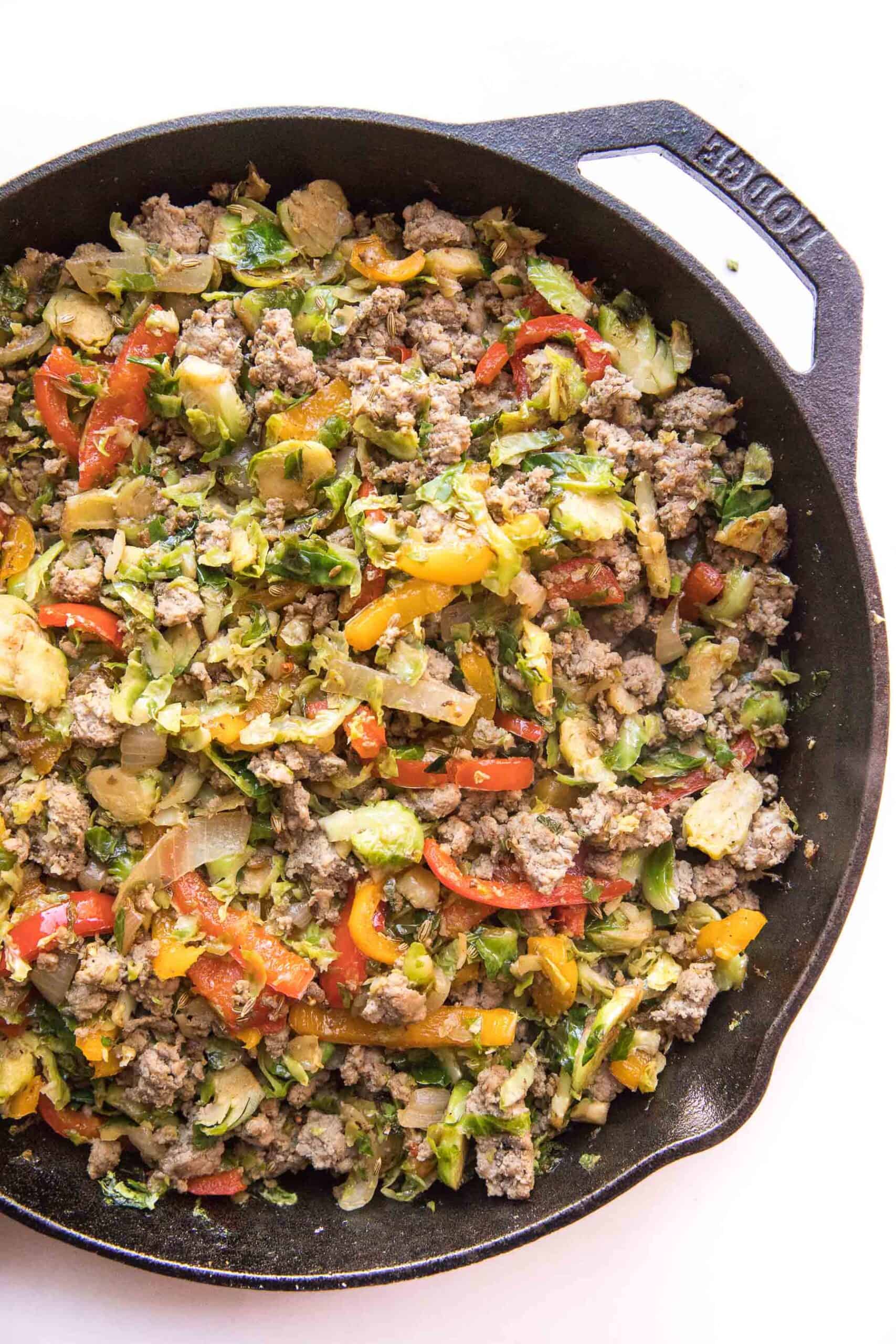 sausage + brussels hash in a cast iron skillet