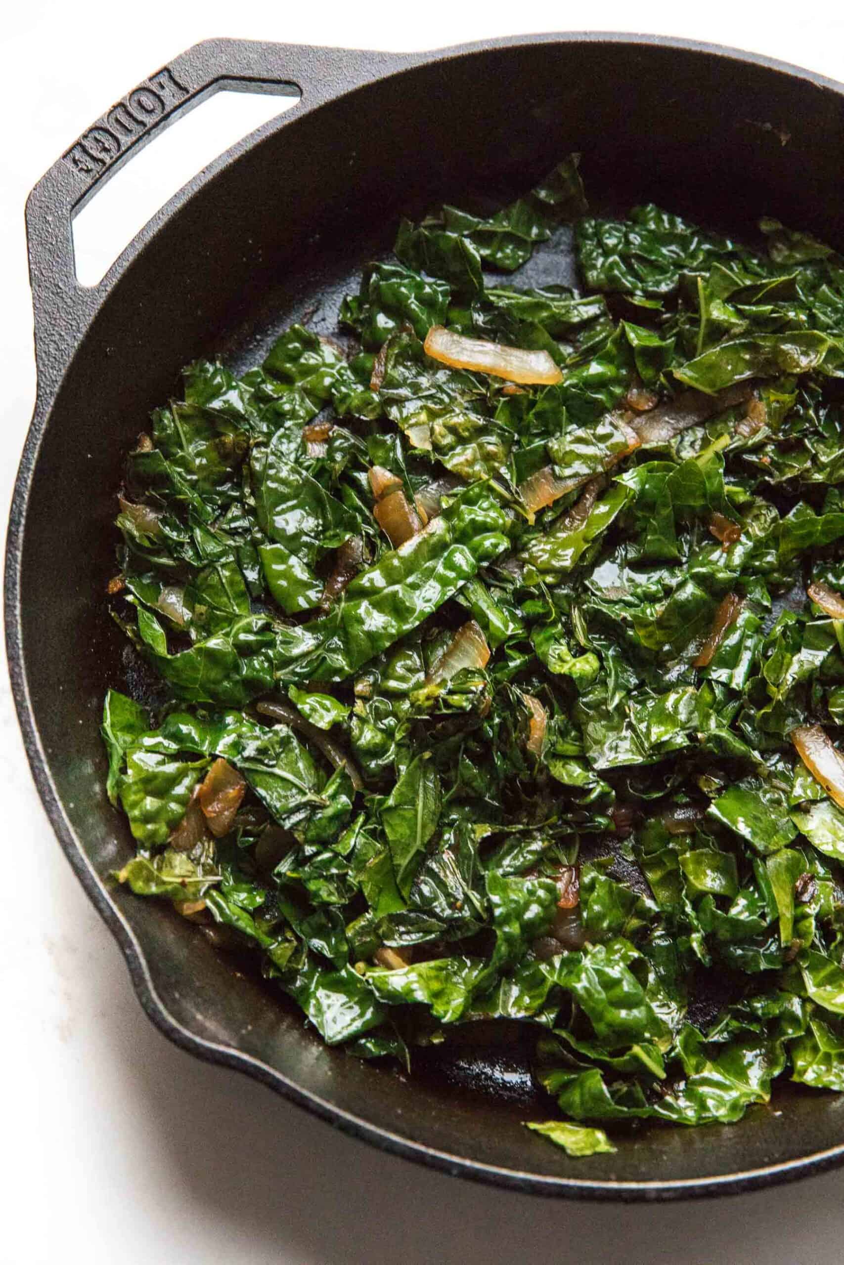 sauteed kale in a cast iron skillet