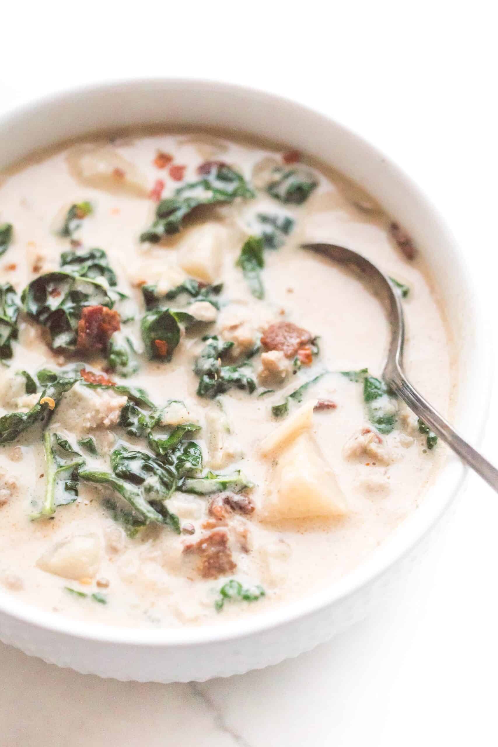 spoon in a bowl of whole30 + keto zuppa toscana