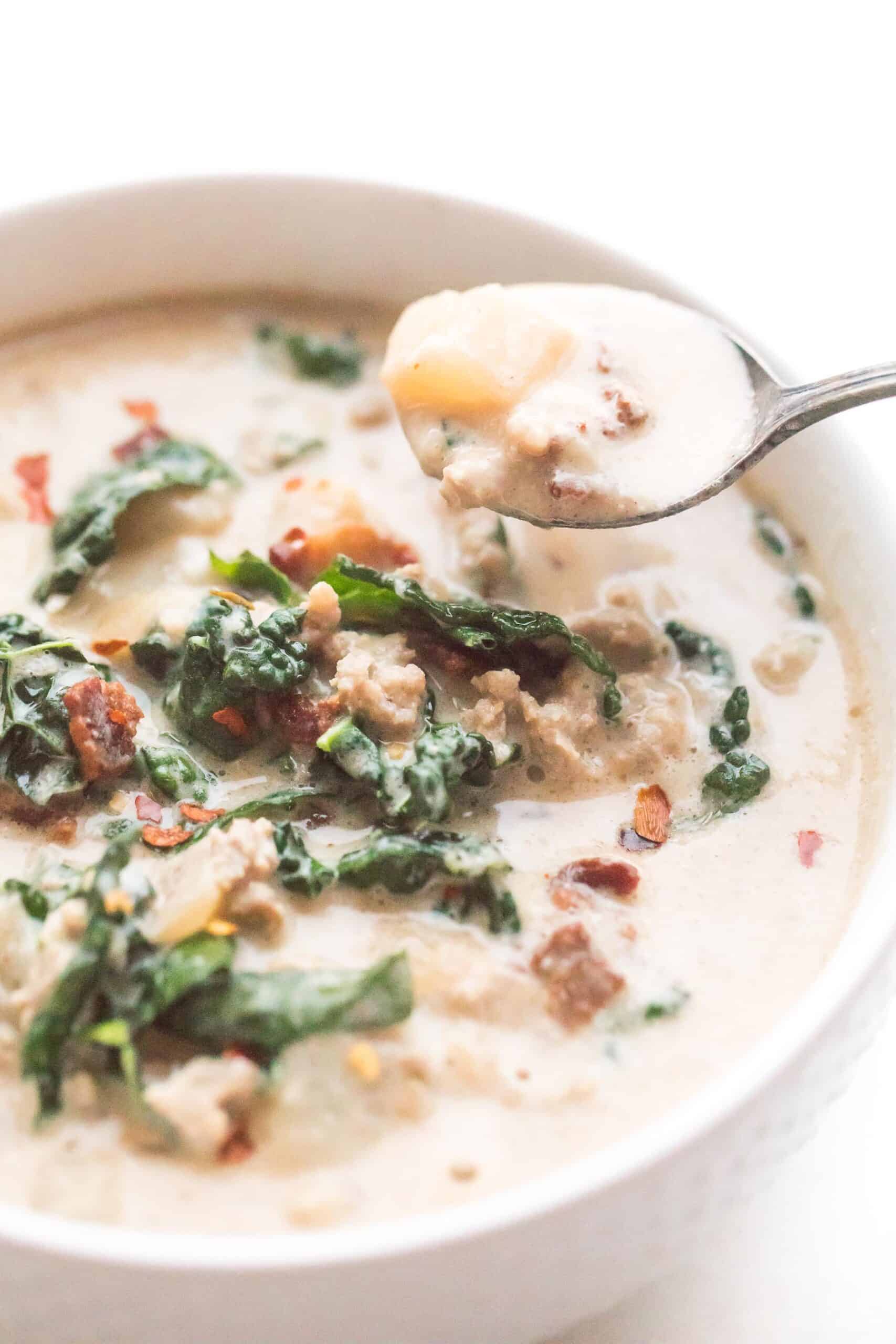 spoon in a bowl of whole30 + keto zuppa toscana