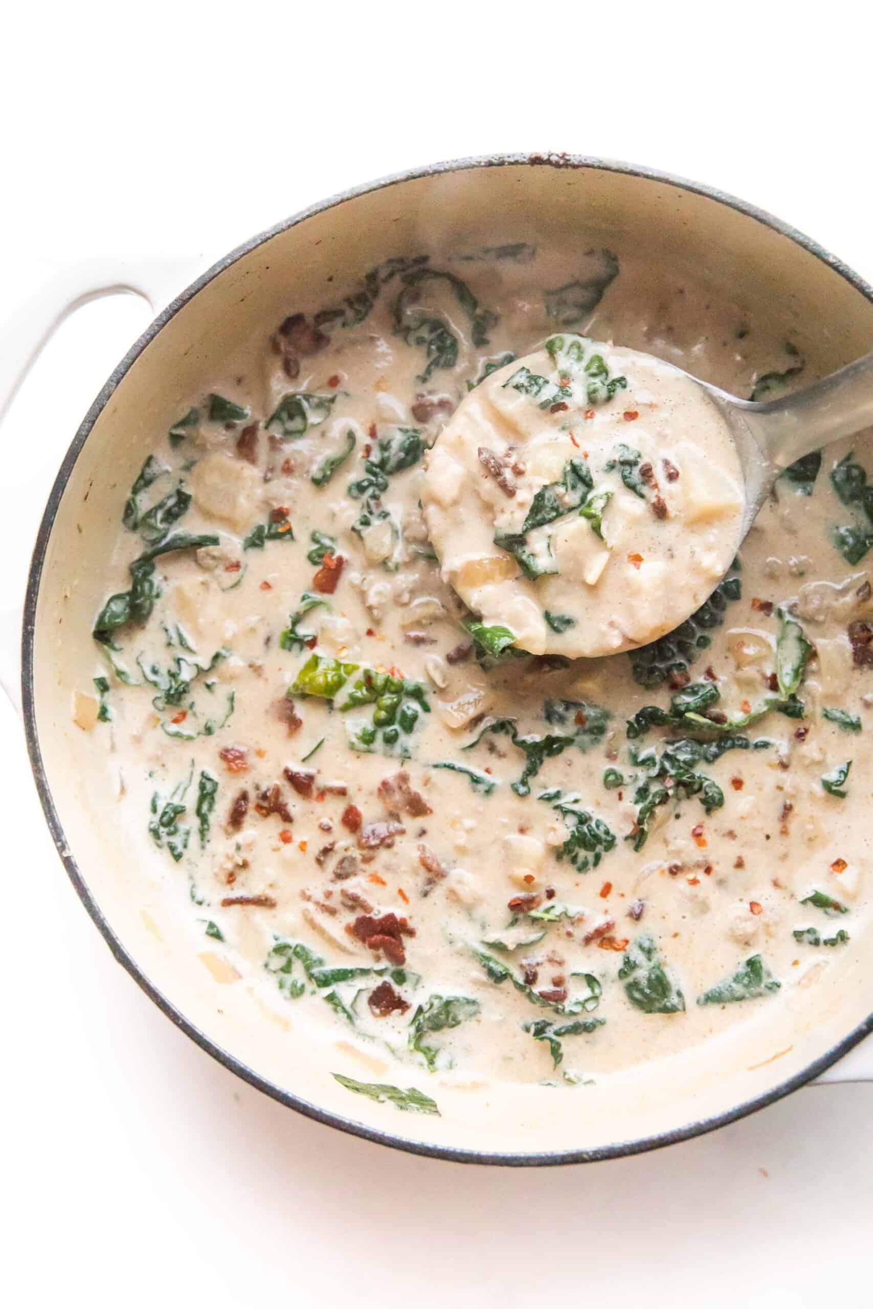 ladle in a pot of whole30 + keto zuppa toscana