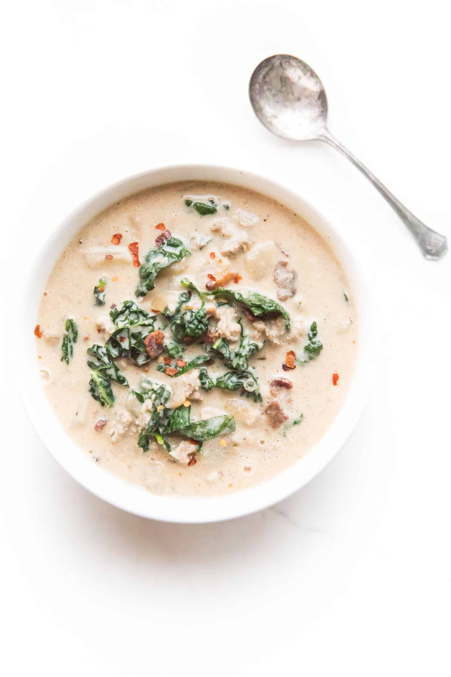 spoon by a bowl of whole30 + keto zuppa toscana