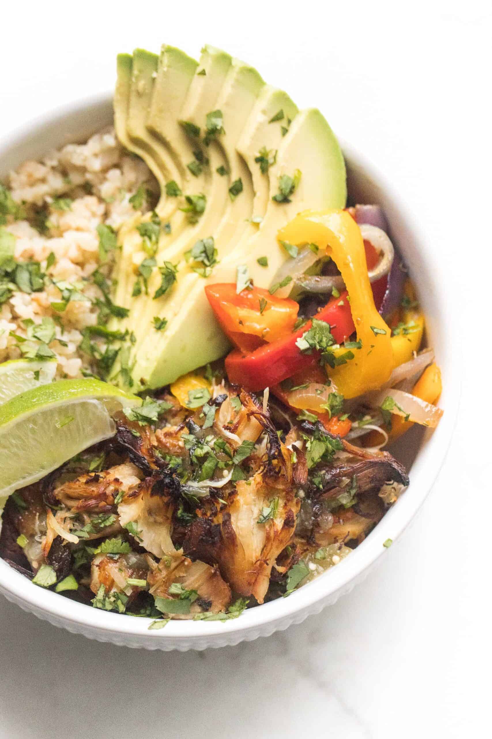 crispy verde chicken burrito bowl on a white background