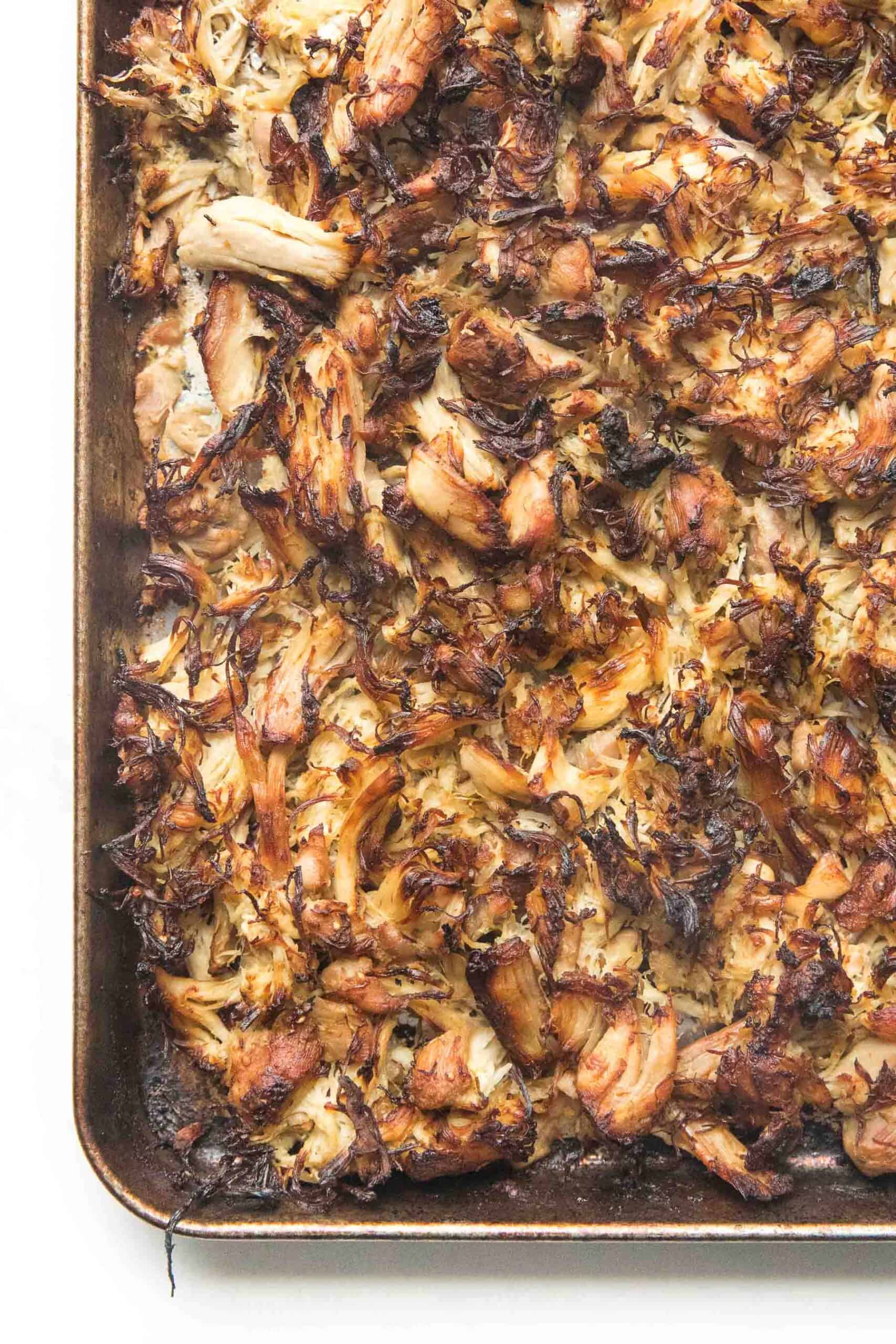 crispy verde chicken on a rimmed baking sheet