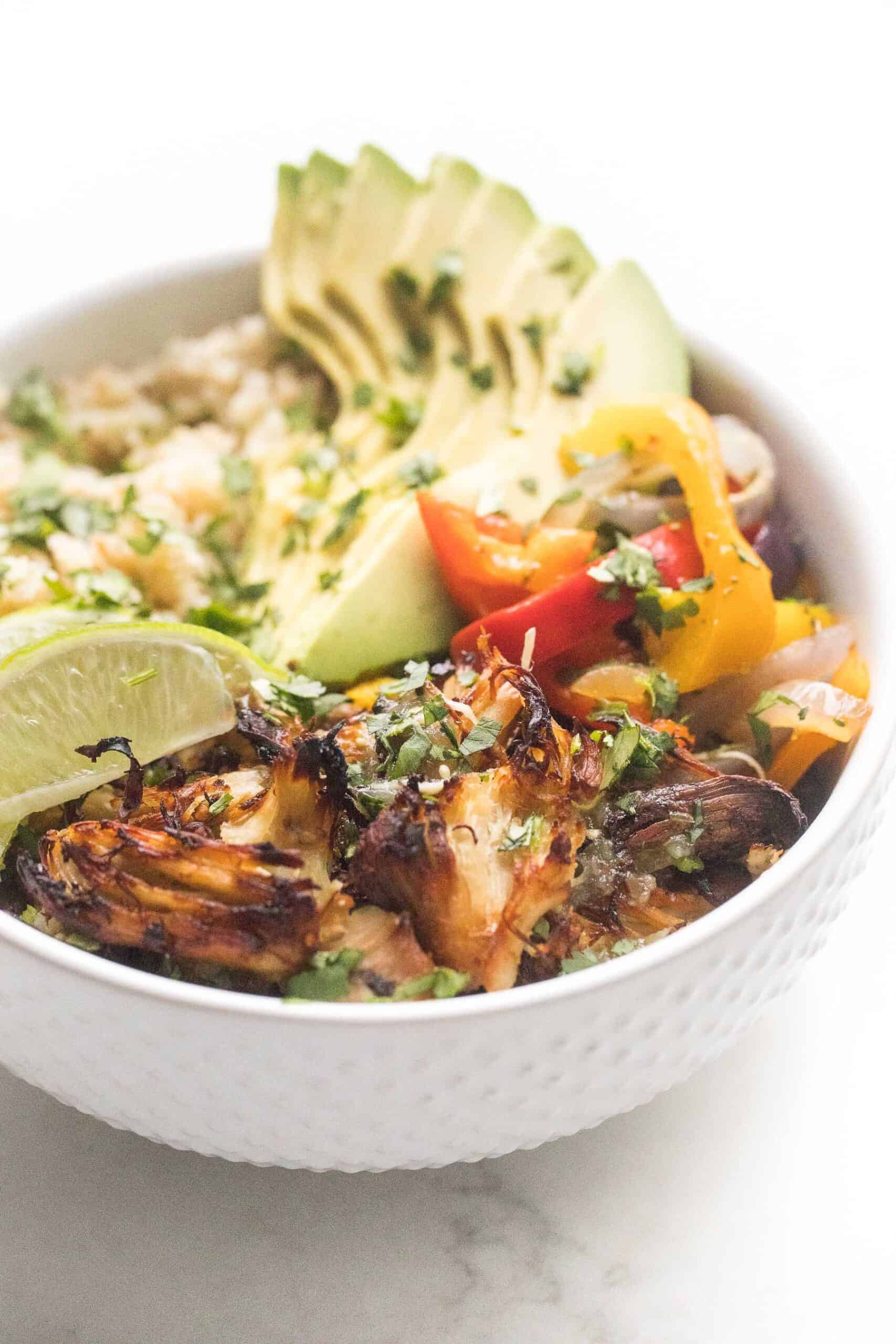 crispy verde chicken burrito bowl on a white background