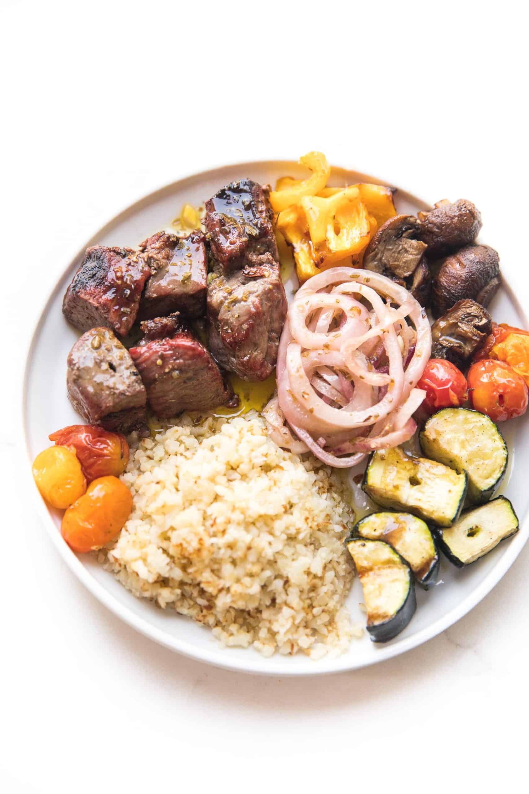 plate of steak and vegetable kabobs