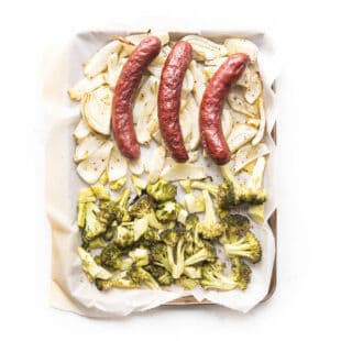 sausage, roasted fennel and broccoli on a white plate and background