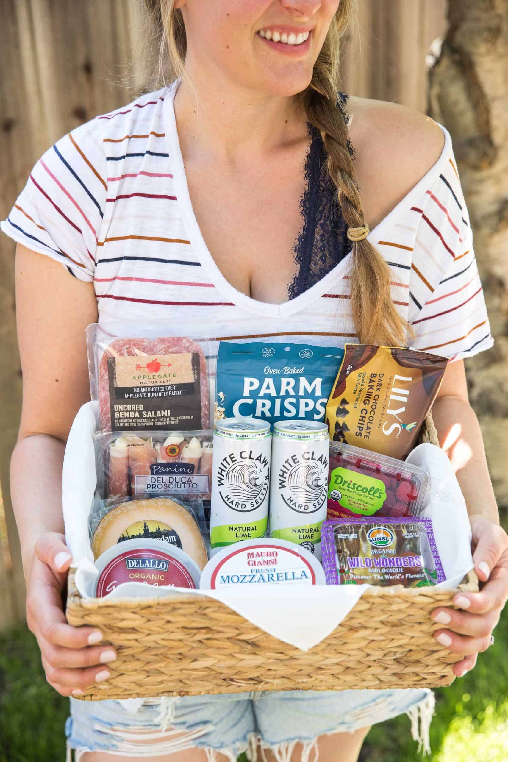 girl holding a picnic basket full of keto goodies