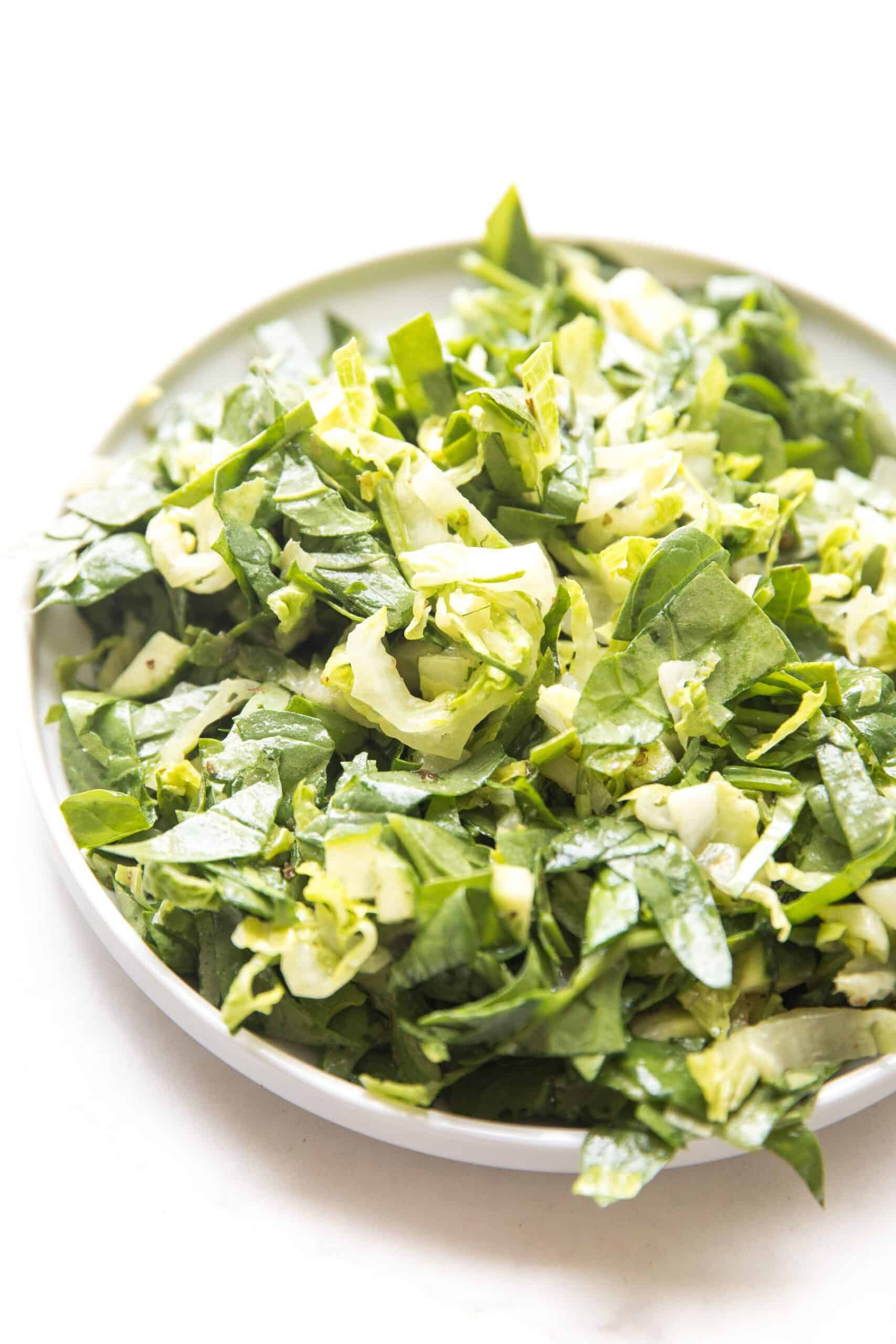 green salad on a white plate and background