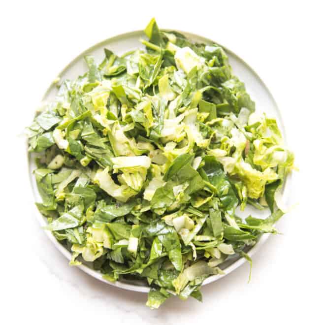 green salad on a white plate and background