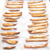 baked french fries on a rimmed baking sheet