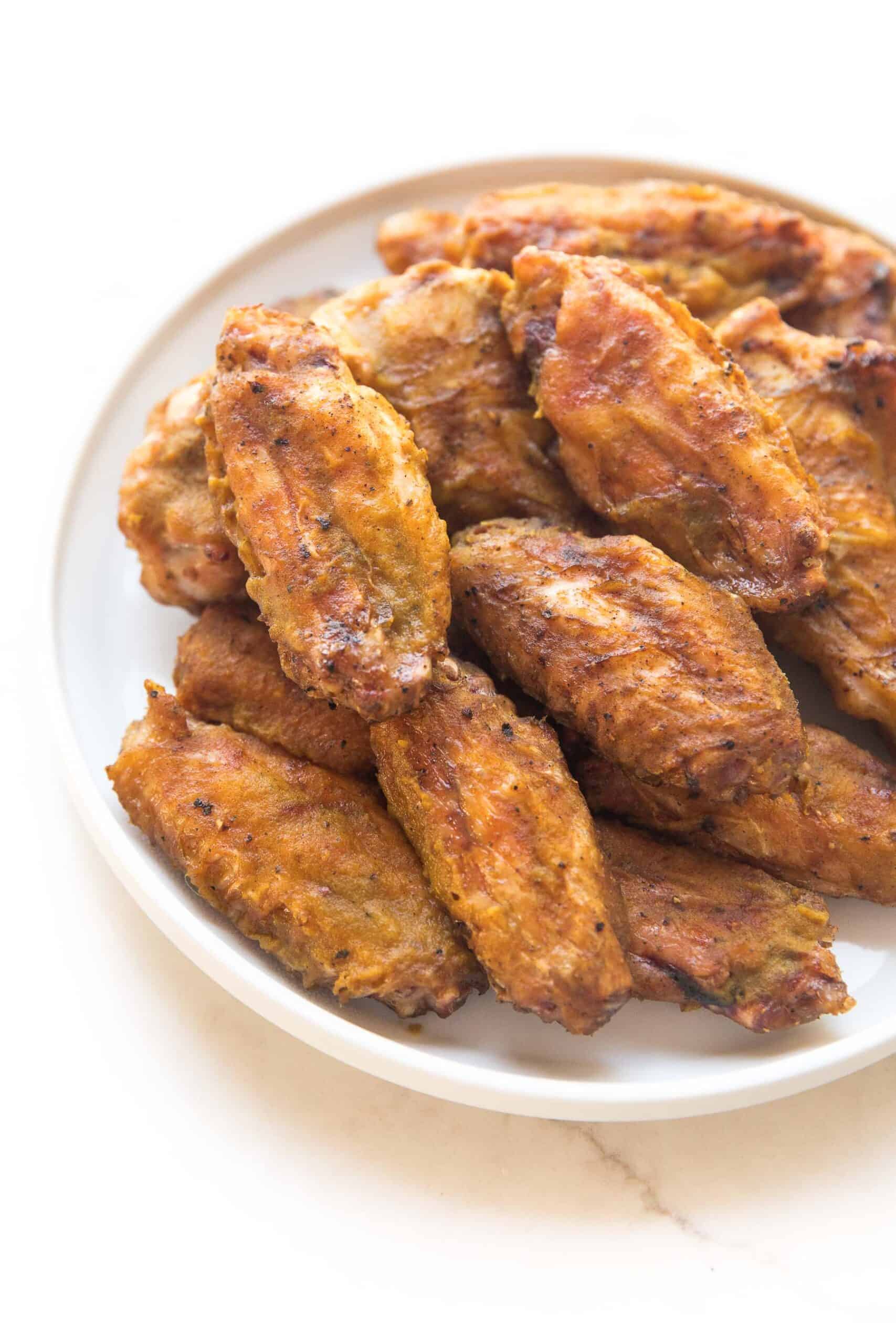 BBQ CHICKEN WINGS ON A WHITE PLATE