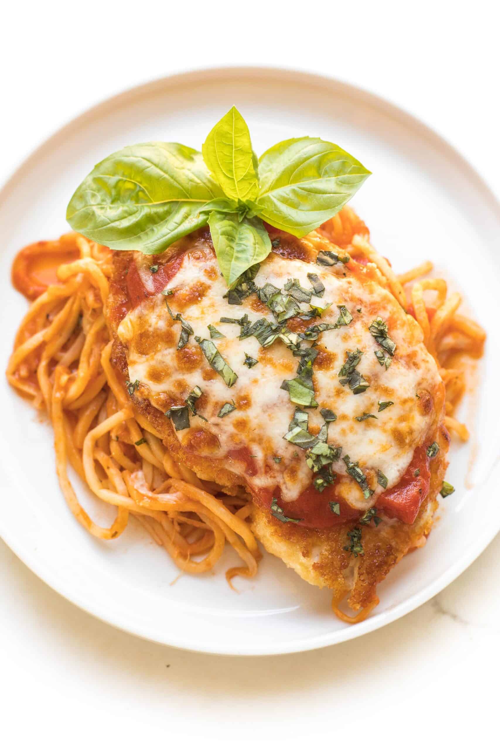 keto chicken parmesan on a white plate and background