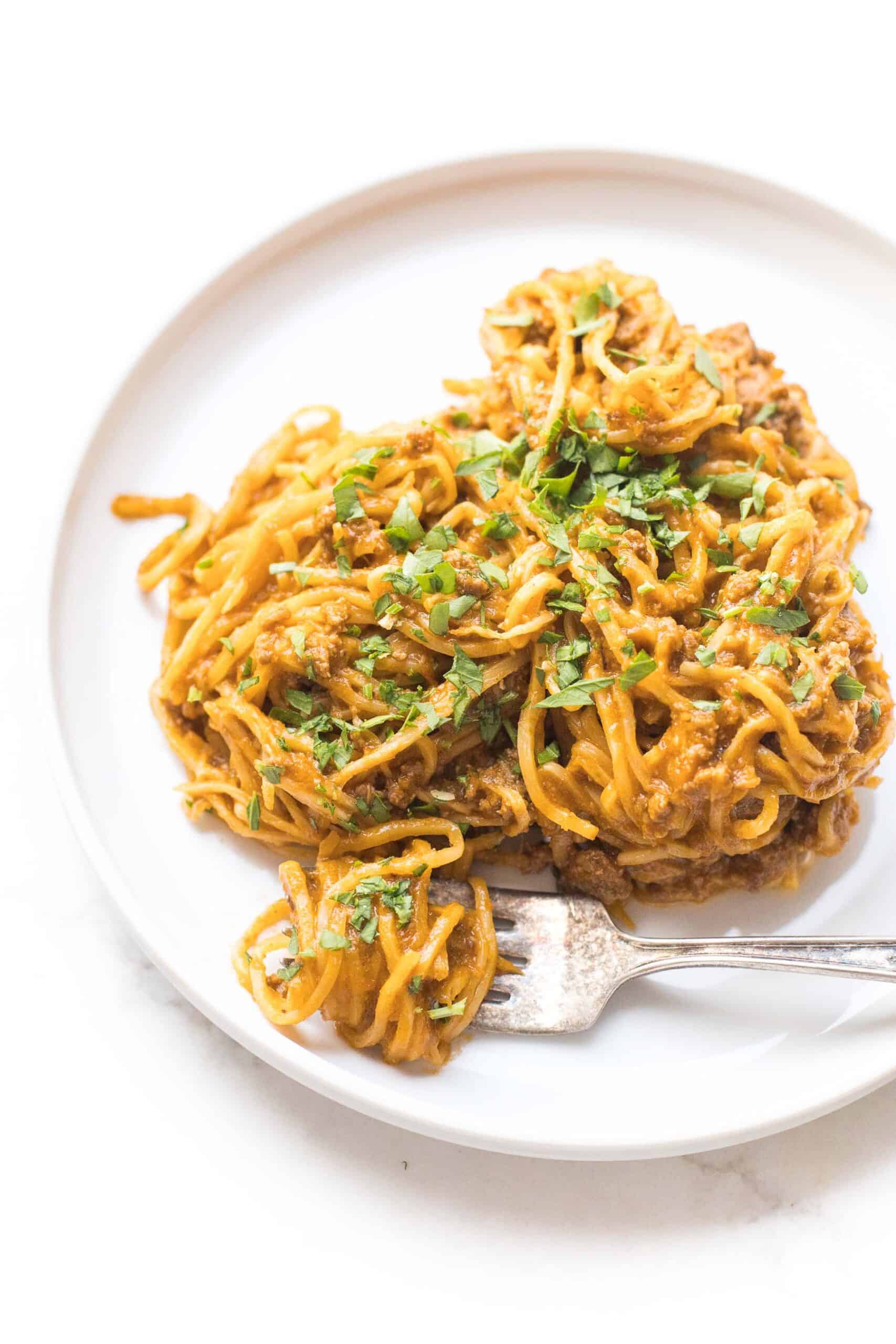 hearts of palm pasta with red meat sauce on a white plate