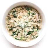 Instant Pot Keto Creamy Mushroom Chicken cauliflower rice Casserole with spinach and parmesan in a white bowl