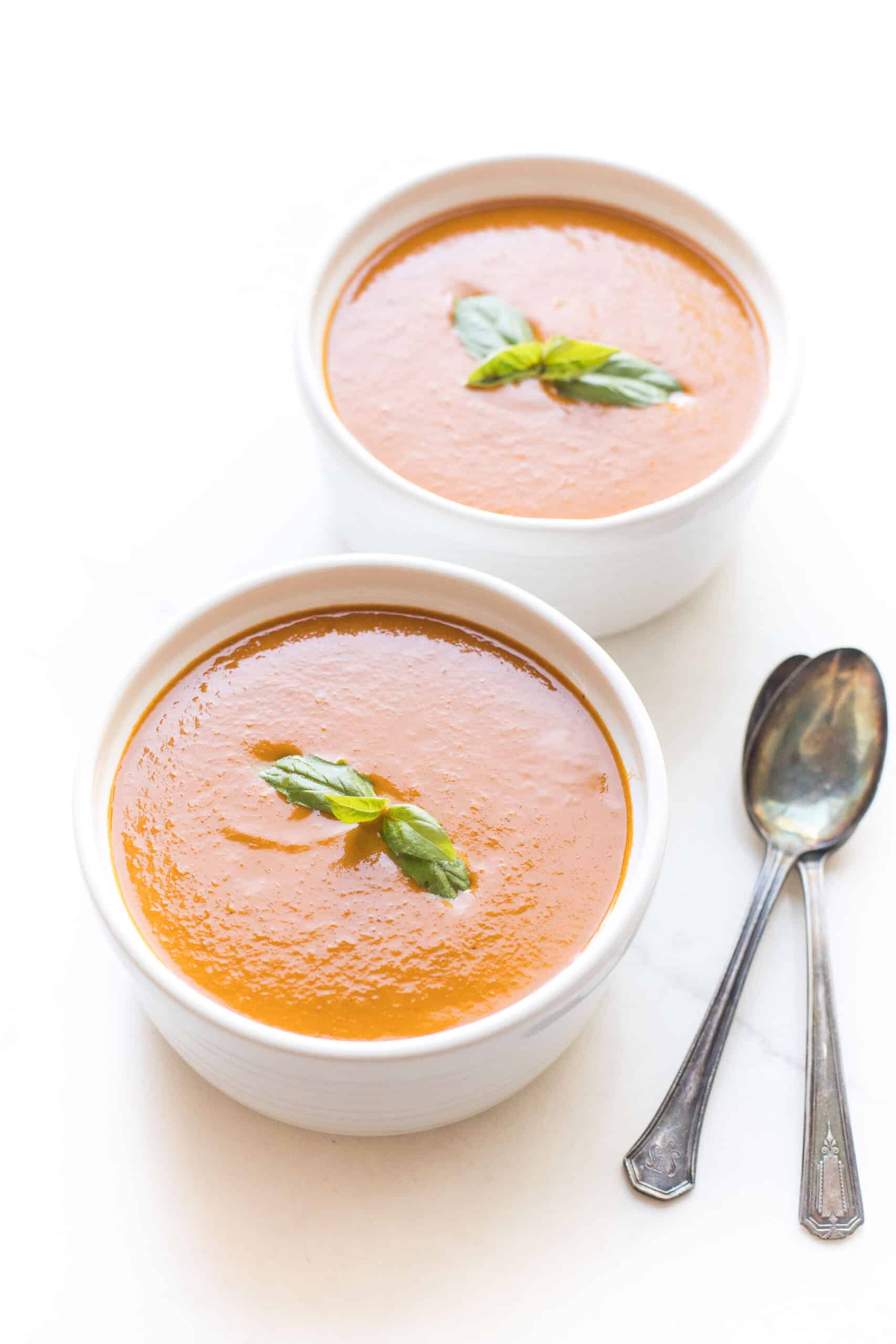 roasted tomato basil soup in a white bowl on a white background