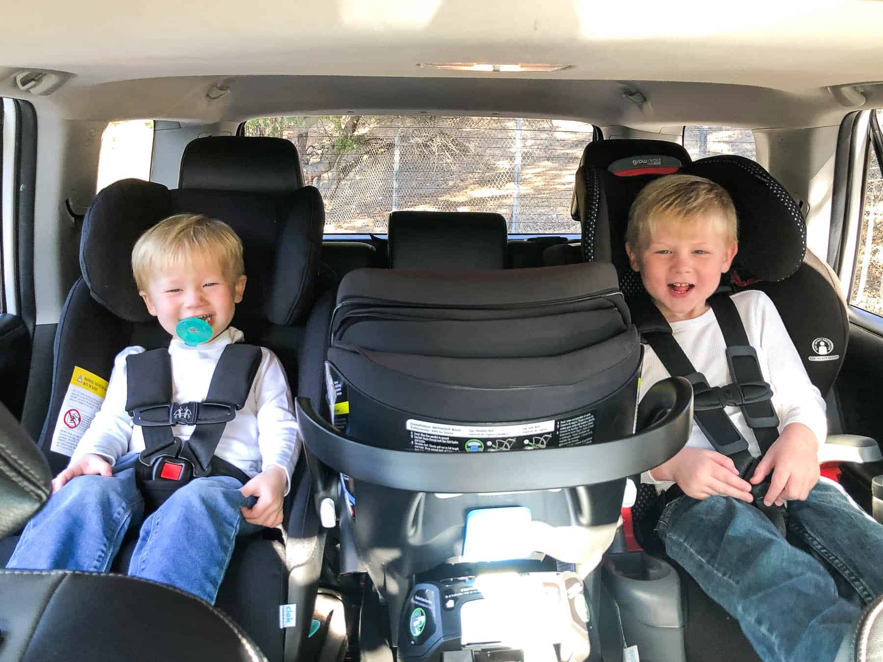 3 car seats across in a row in a 2018 toyota 4runner with 2 toddler boys buckled in