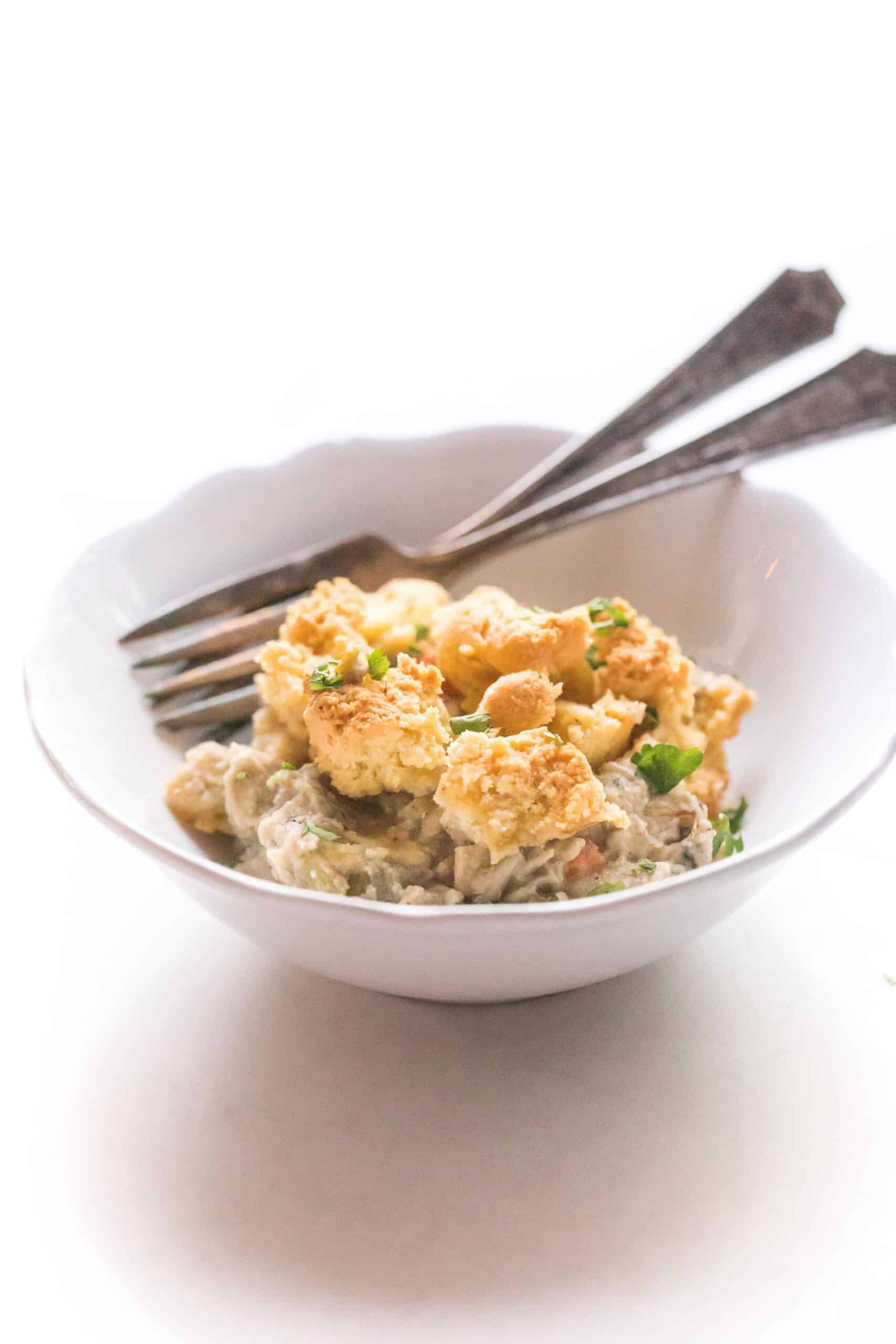 keto chicken pot pie crumble in a white bowl on a white background