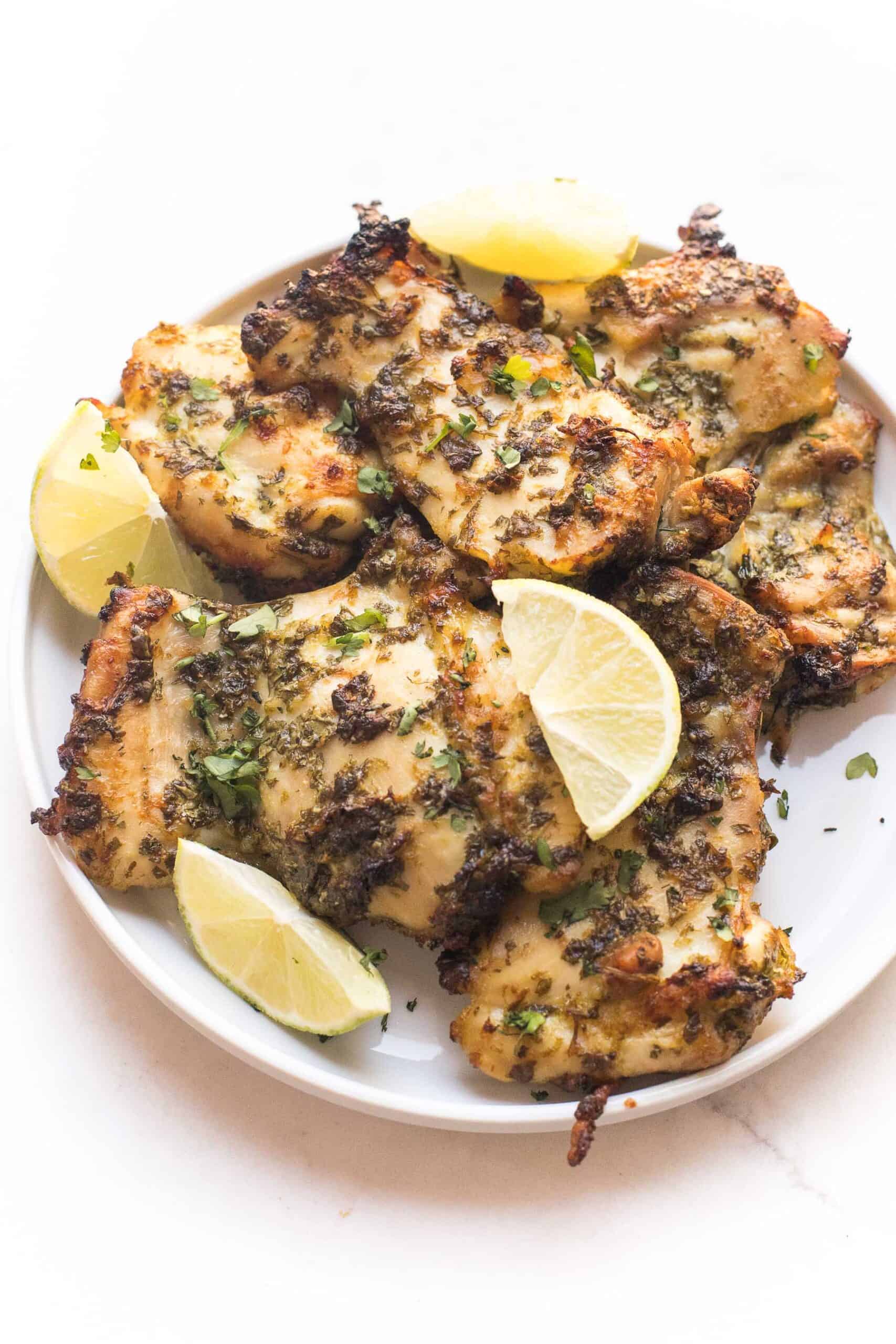 whole30 + keto cilantro lime chicken thighs on a white plate and background