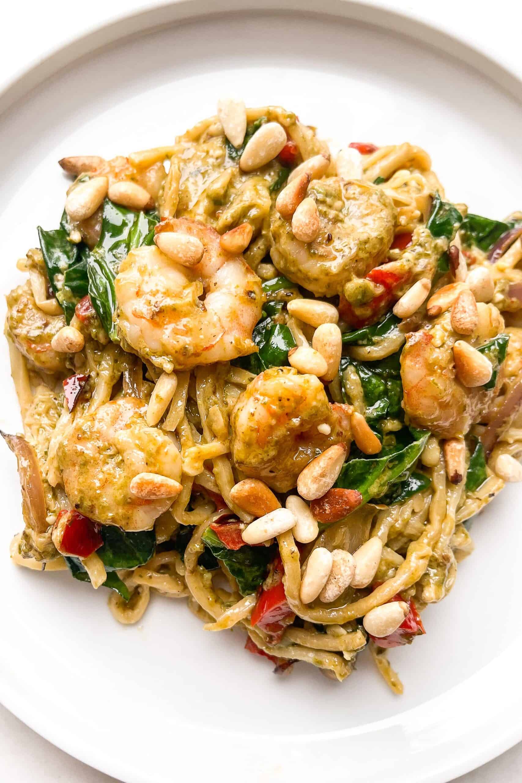 pesto shrimp pasta on a white plate