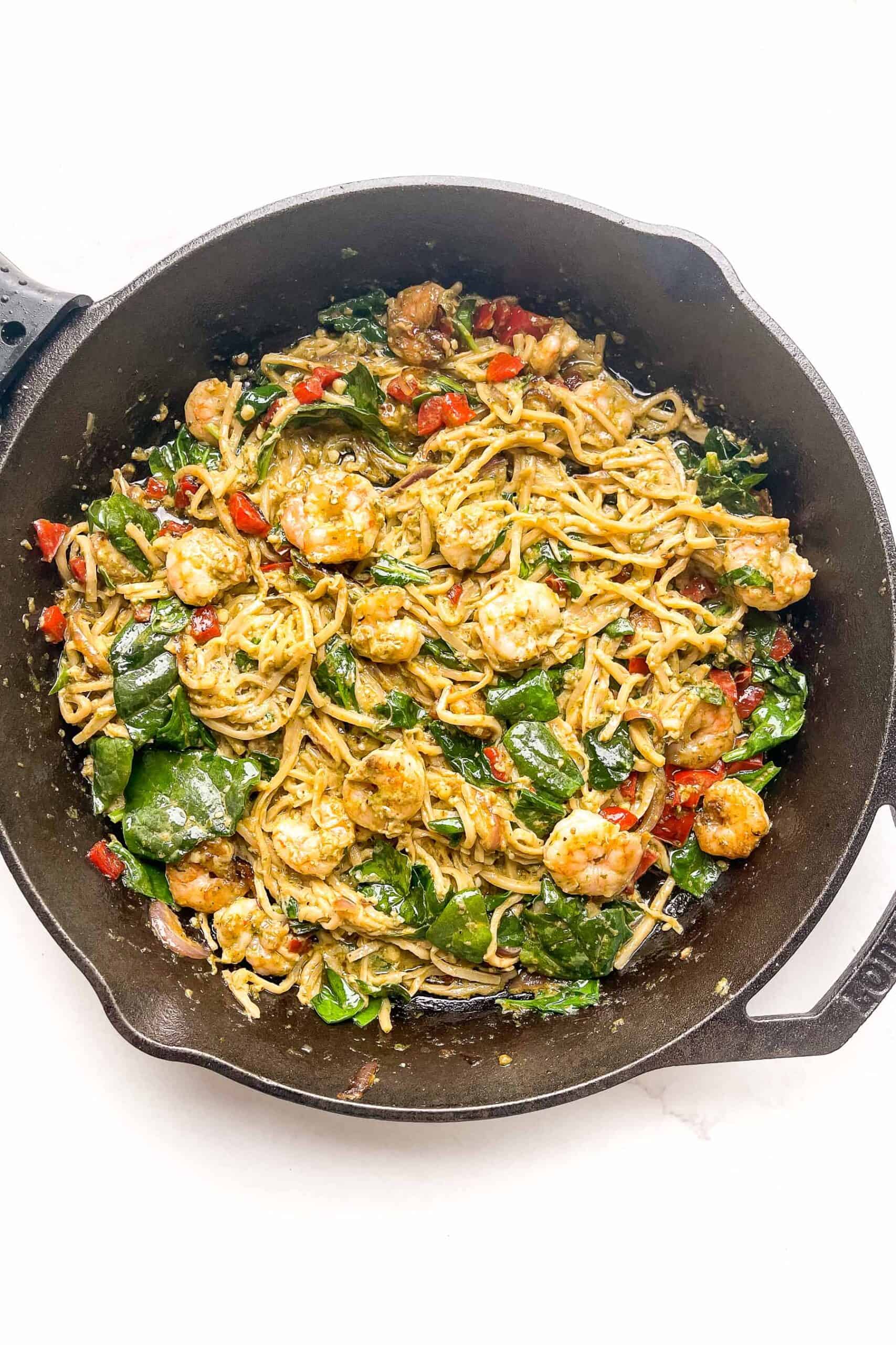 pesto shrimp pasta in a cast iron skillet