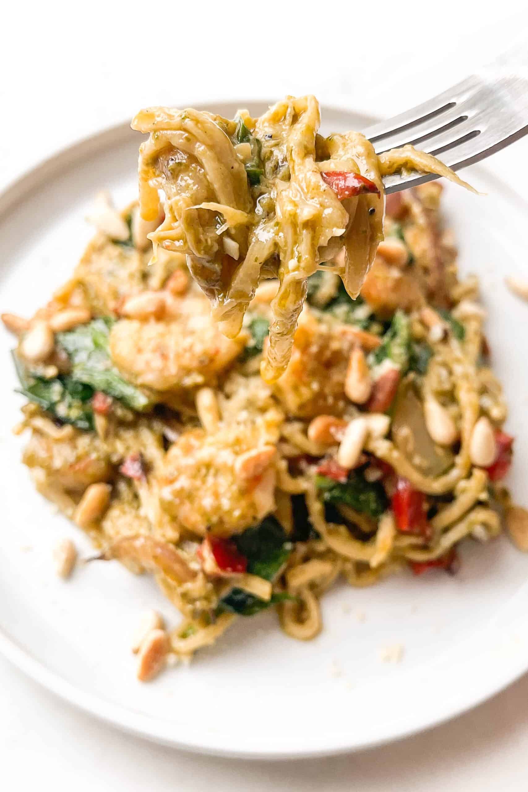 pesto shrimp pasta on a white plate