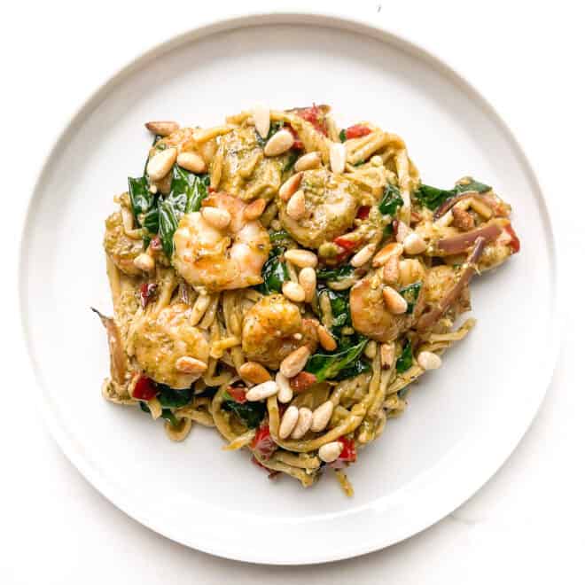 pesto shrimp pasta on a white plate