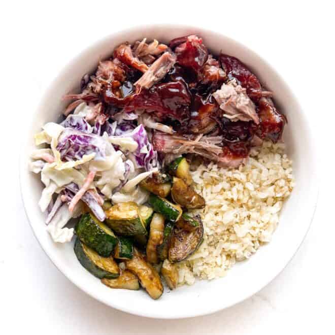 pulled pork and cabbage with frozen cauliflower rice in a white bowl 