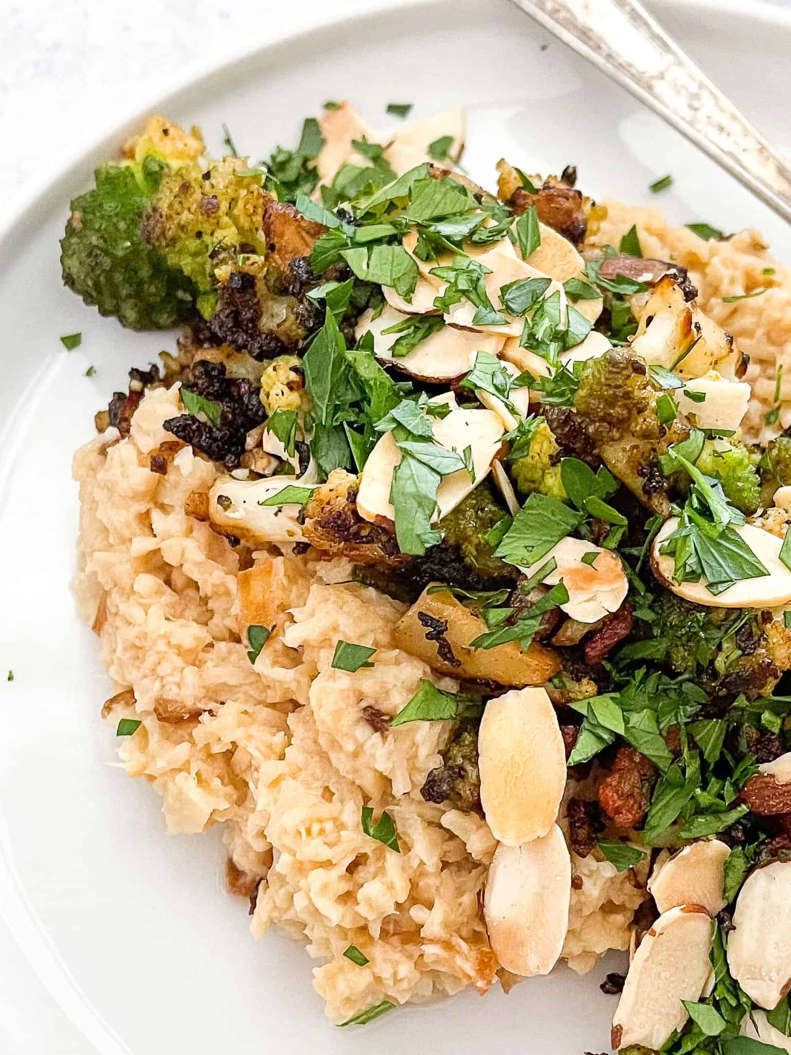 keto risotto with romanesco and bacon on a white plate with a white background