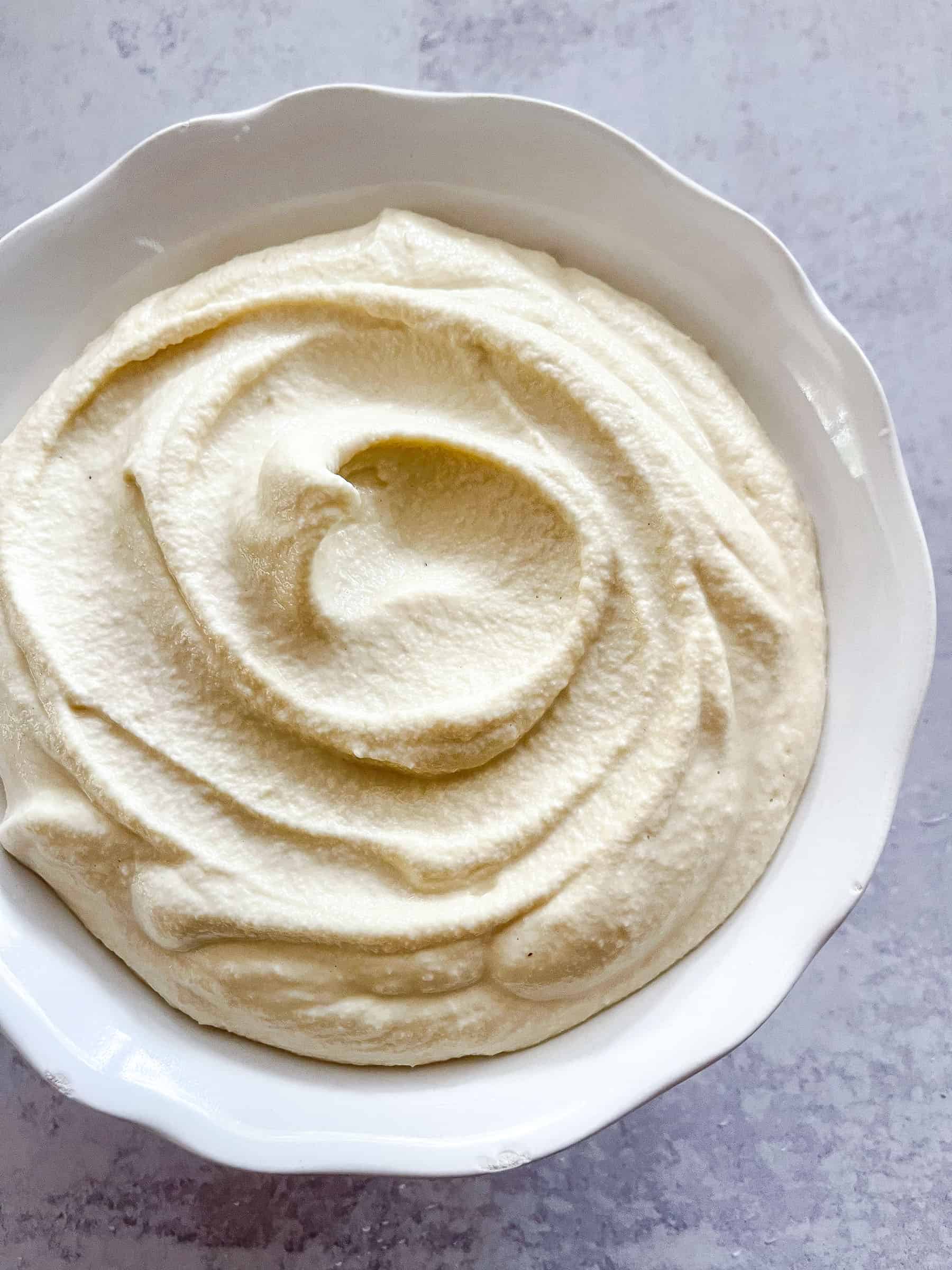 dairy free ricotta in a white bowl with a white background